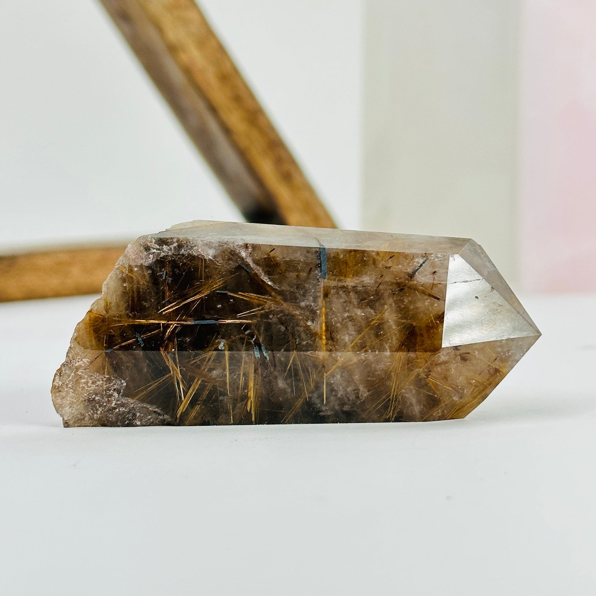 rutilated quartz with decorations in the background