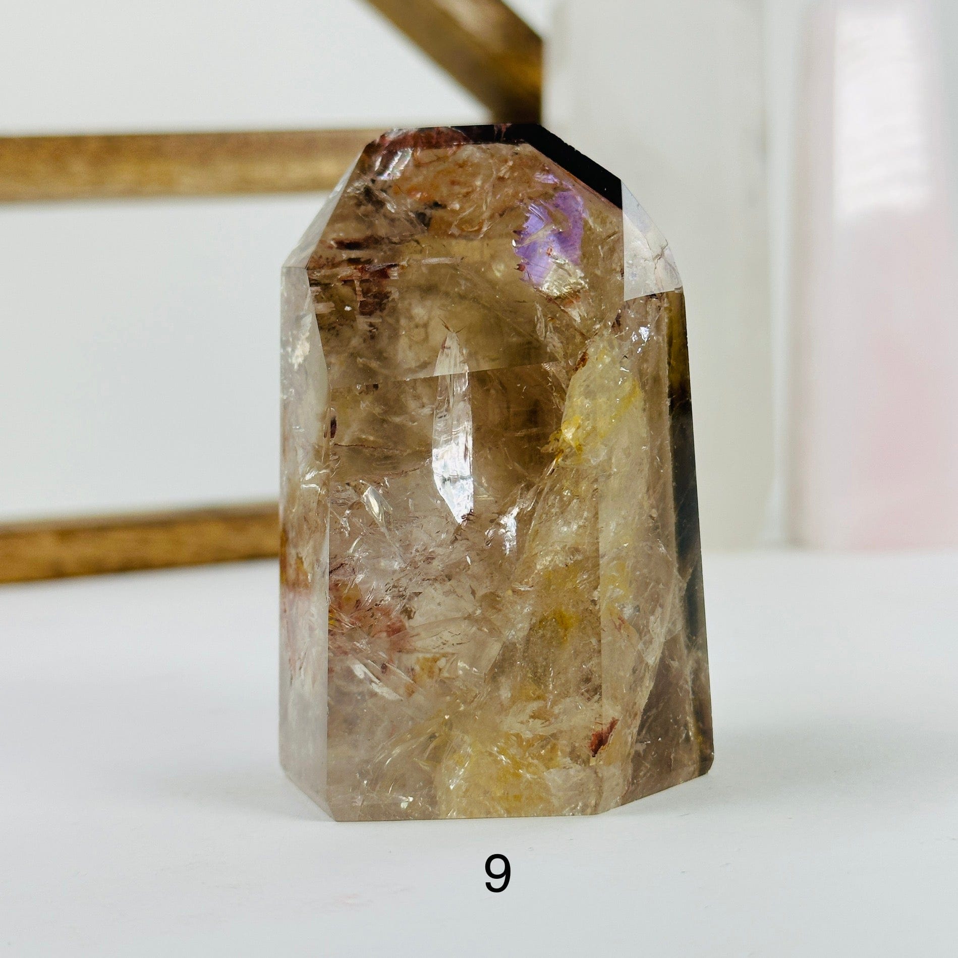 ametrine polished points with decorations in the background