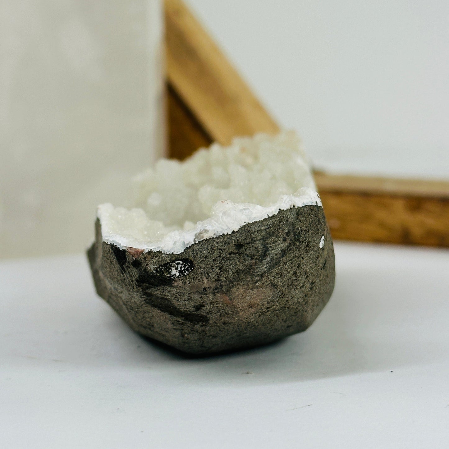 apophyllite on matrix with decorations in the background