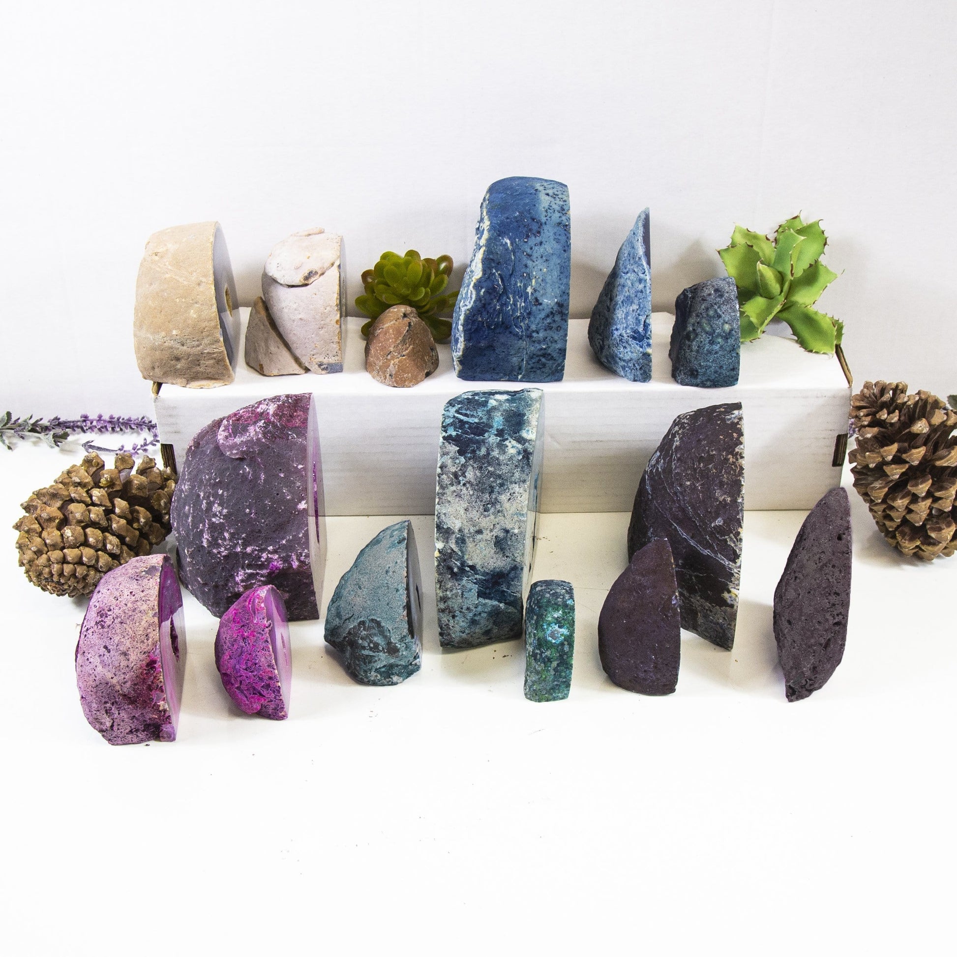 Multiple Agate Half Geode Druzy shown sideways to display width assortment. Products are in an alter with a white background 