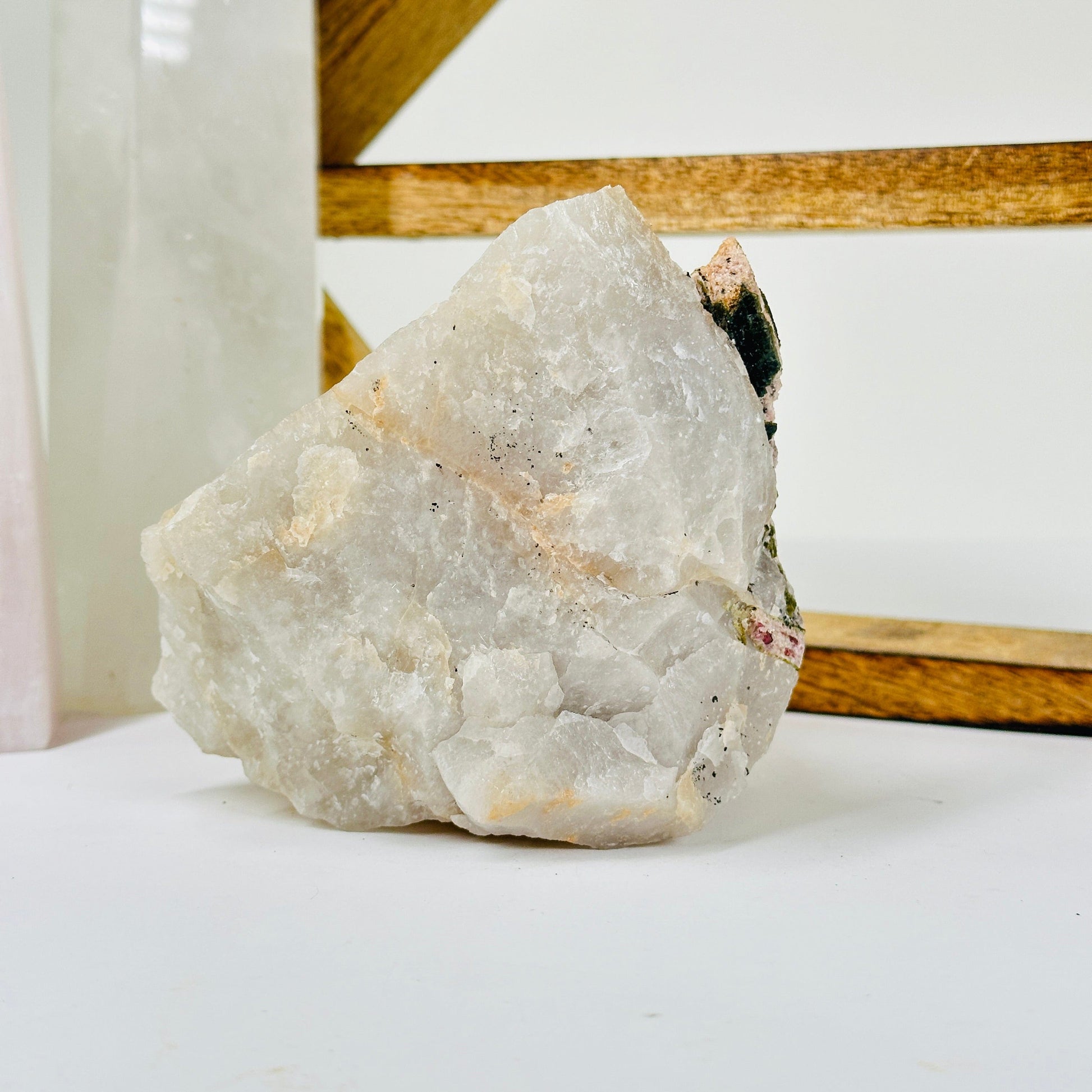 watermelon tourmaline with decorations in the background