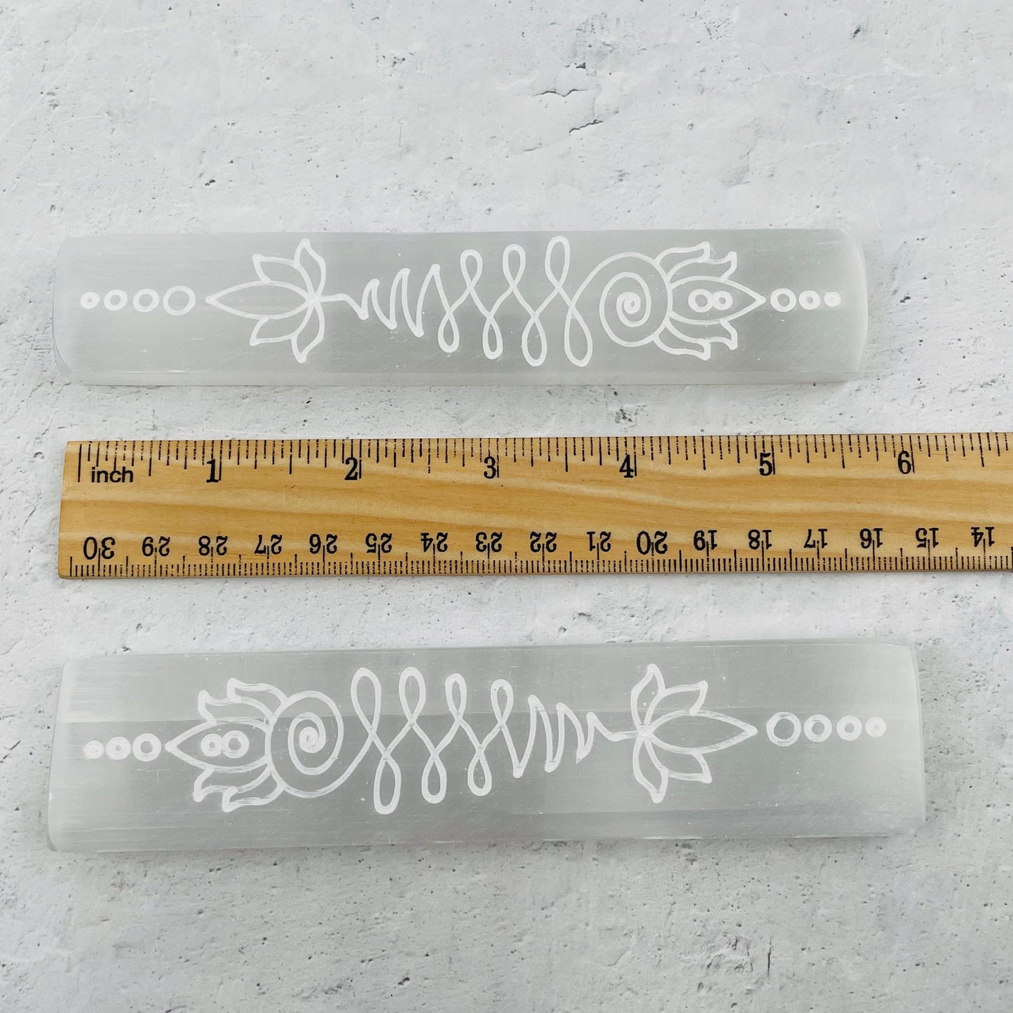 selenite bar next to a ruler for size reference 