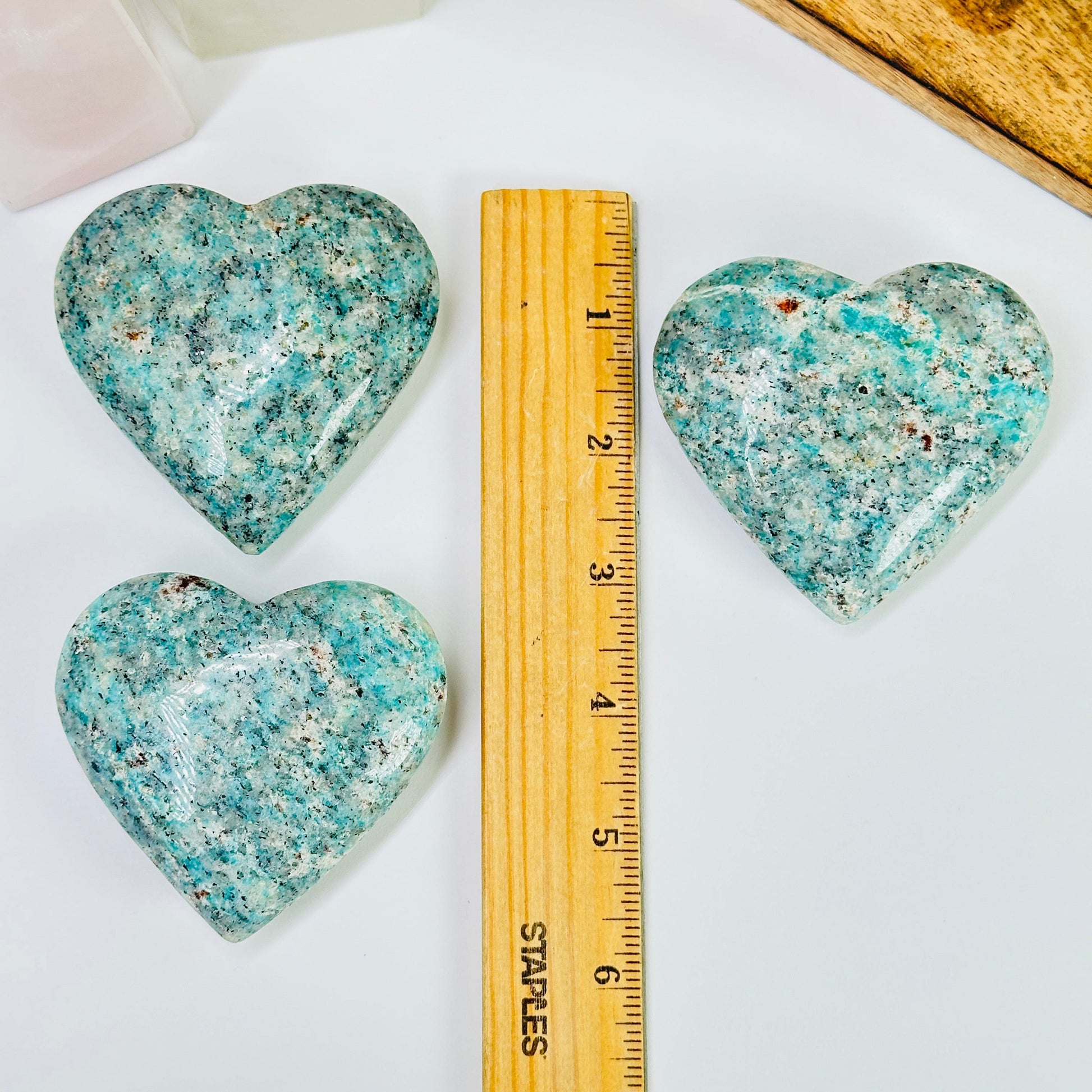 amazonite heart with decorations in the background