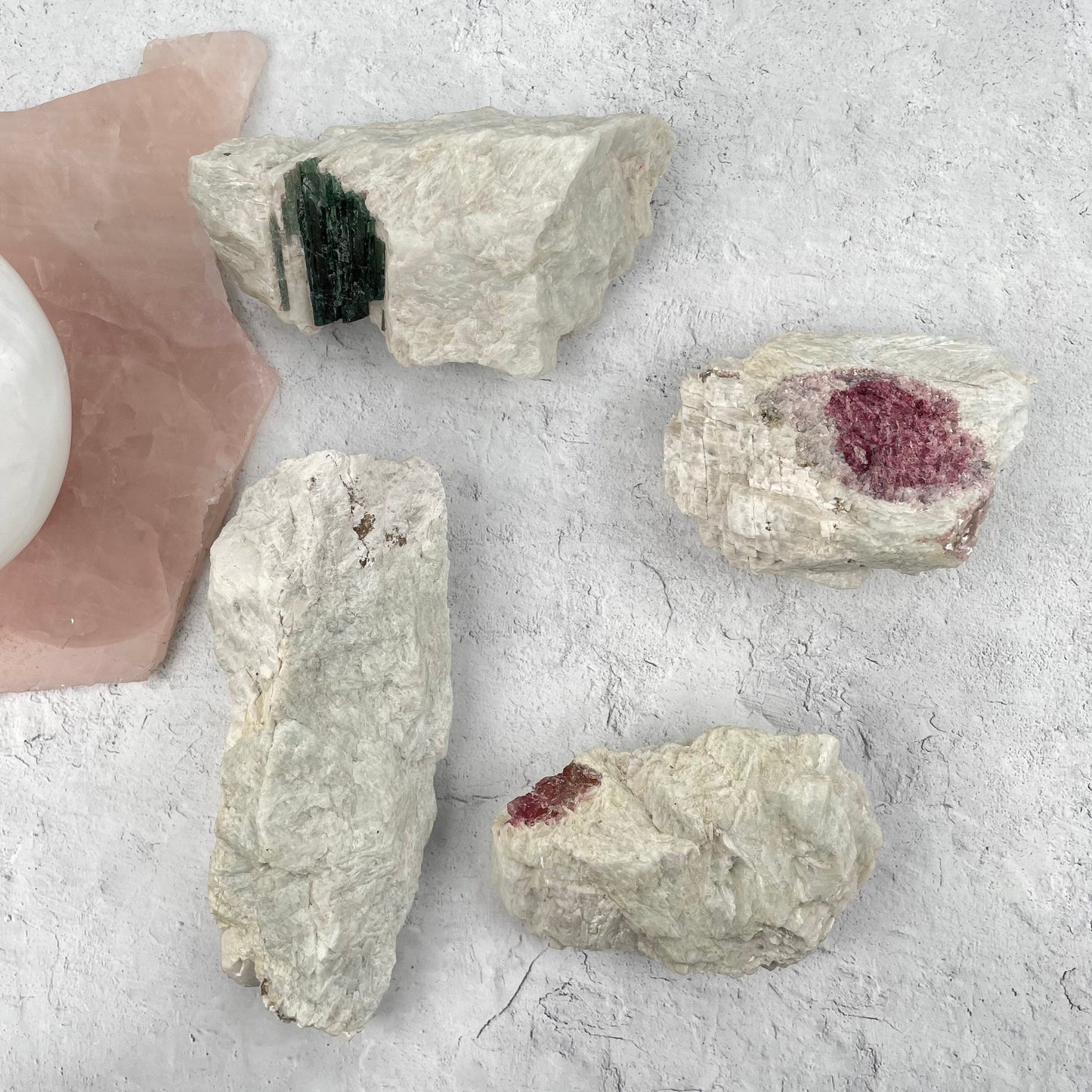 multiple watermelon tourmaline clusters displayed to show the differences in the sizes and color shades 
