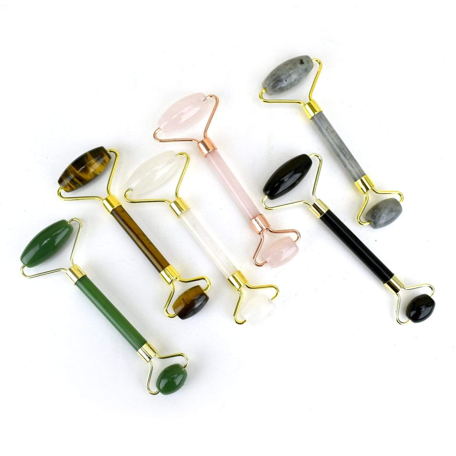 Stone Facial Rollers  of assorted stones on a table
