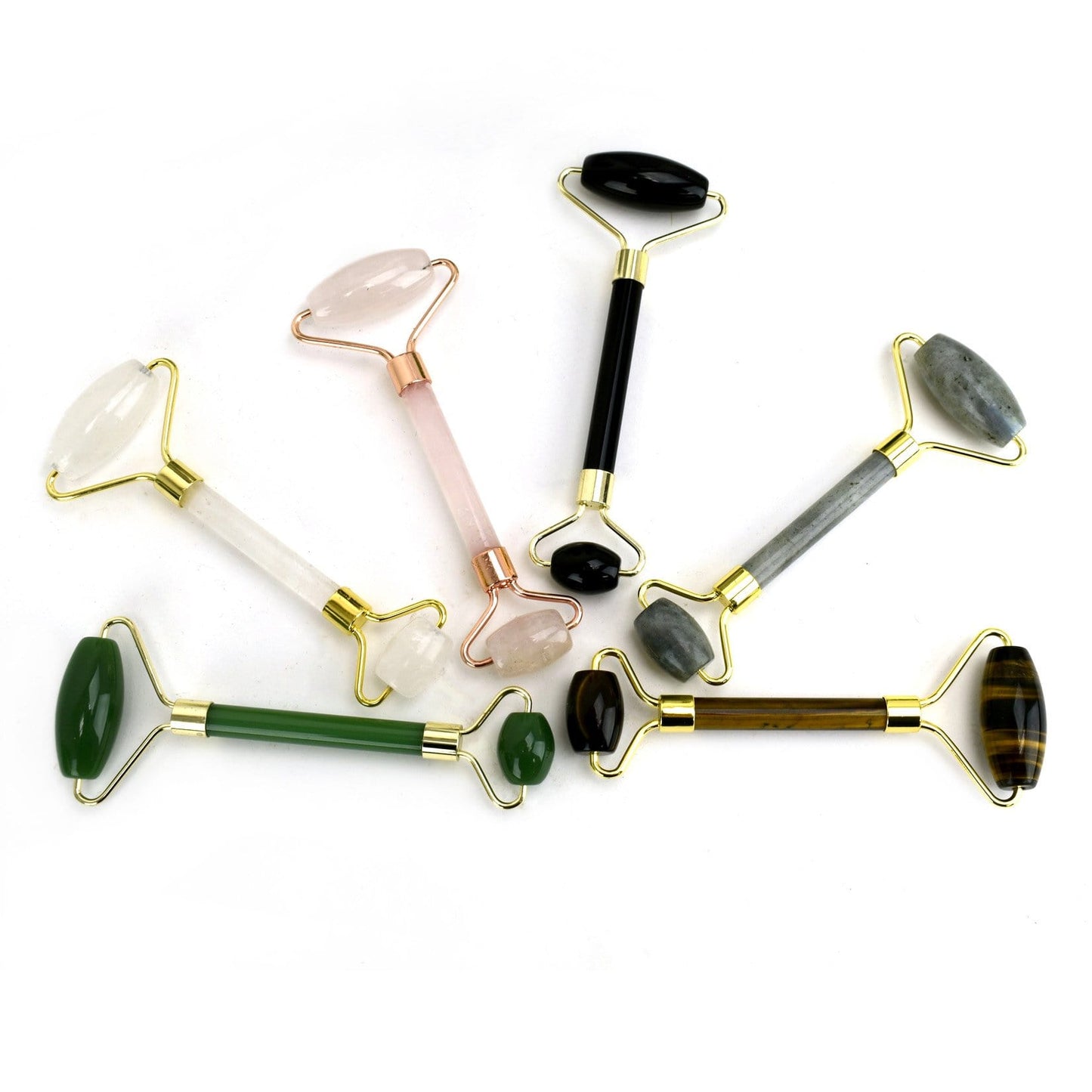 assorted Stone Facial Rollers fanned out on a table