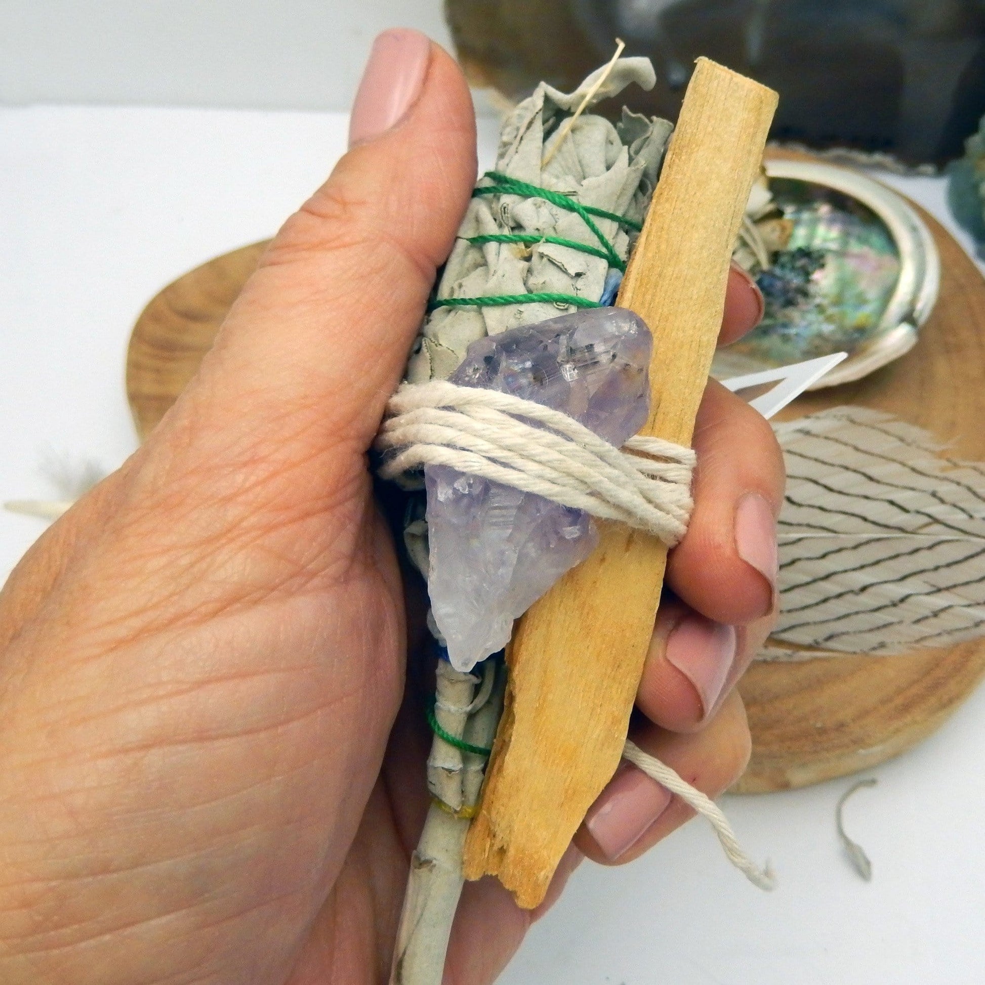sage bundle with amethyst in hand for size reference and possible variation