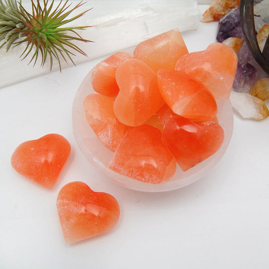 orange selenite puffy hearts displayed as home decor 