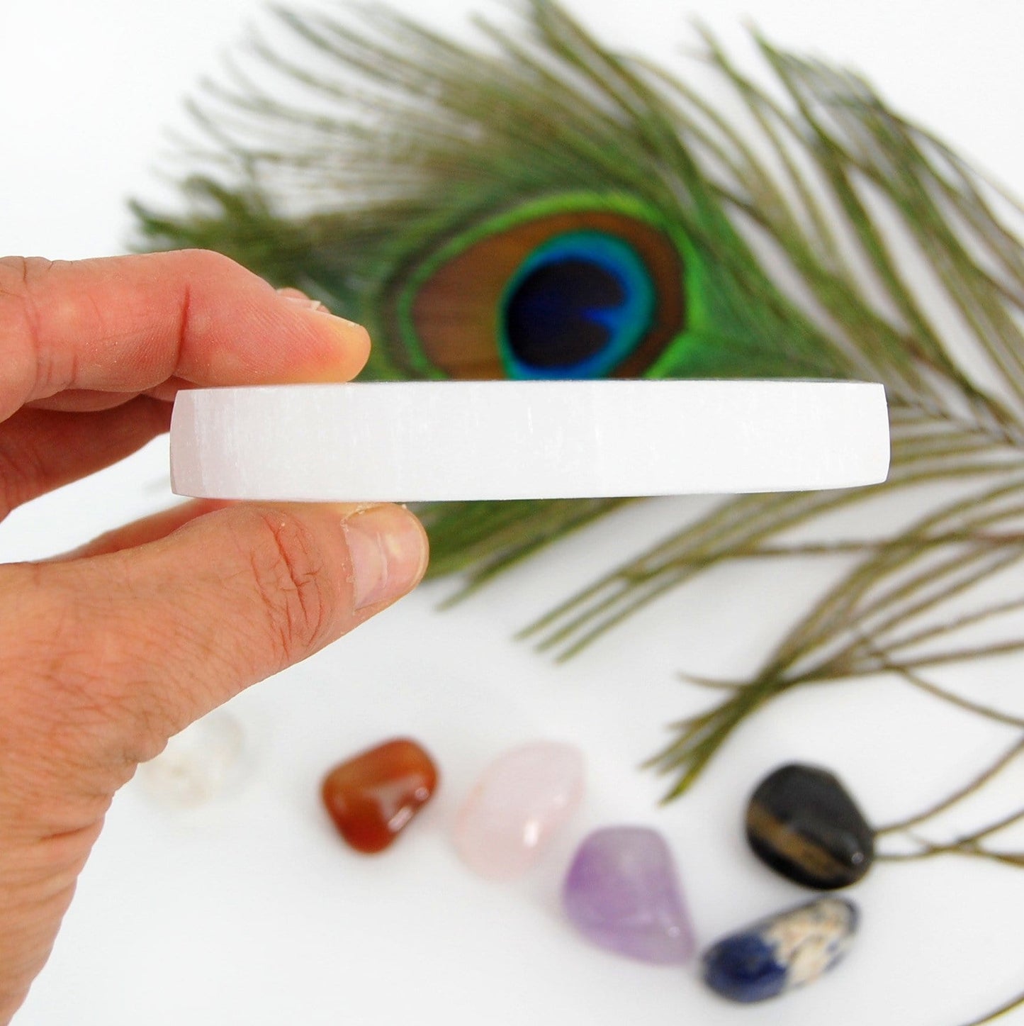 side view of selenite charging plate in hand for thickness