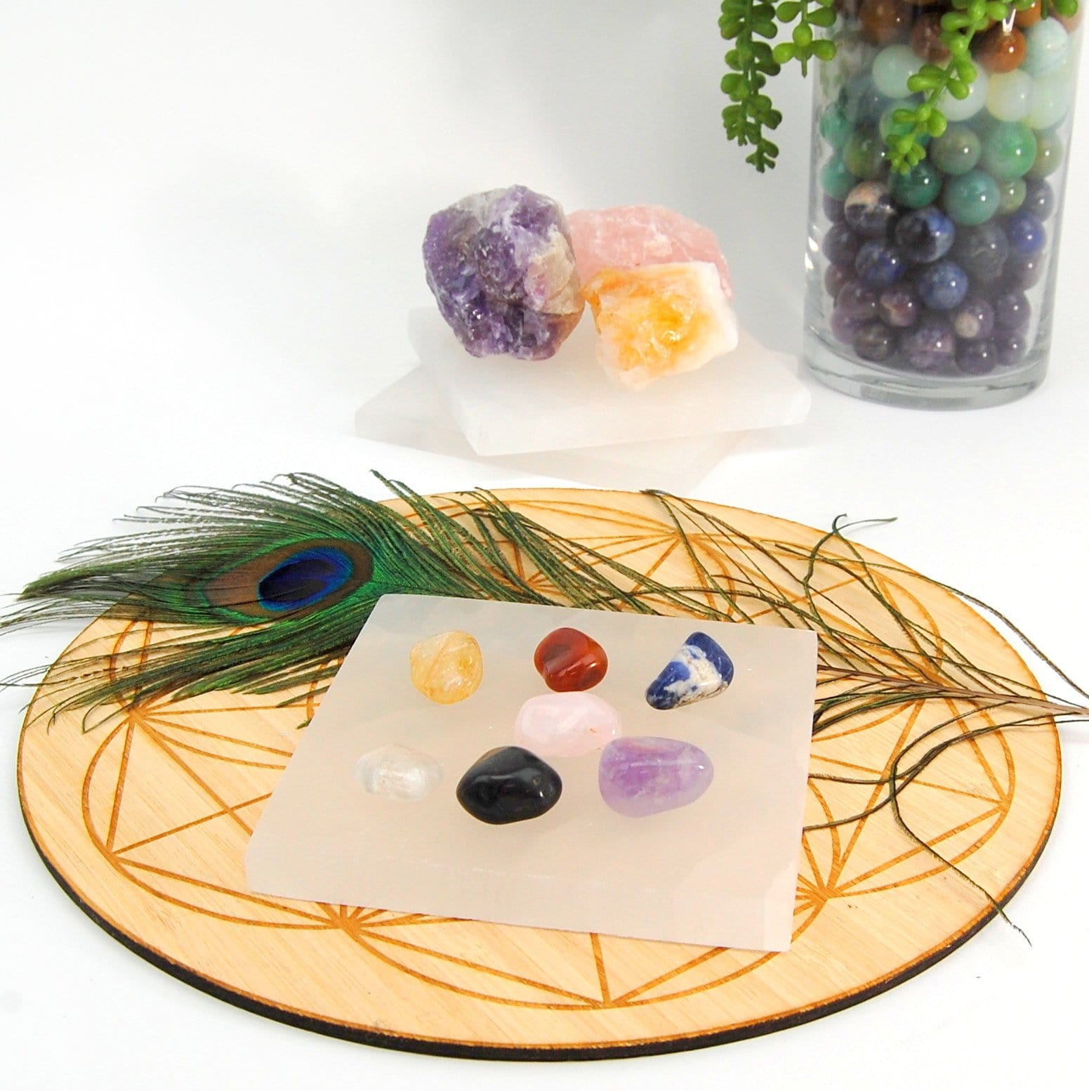 angled view of square selenite charging plate with stones