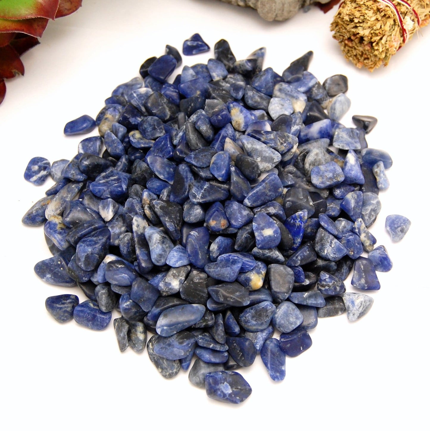 one pound of tumbled sodalite small stones on white background 