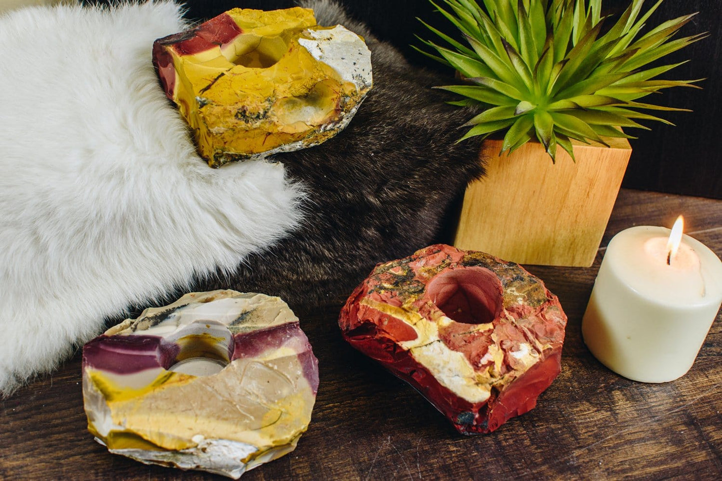 3 mookaite candle holders on a wood background