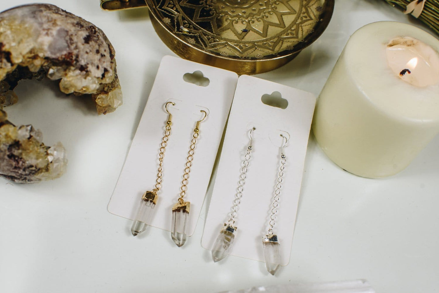 Crystal quartz points hanging from a chain in gold and silver plated.