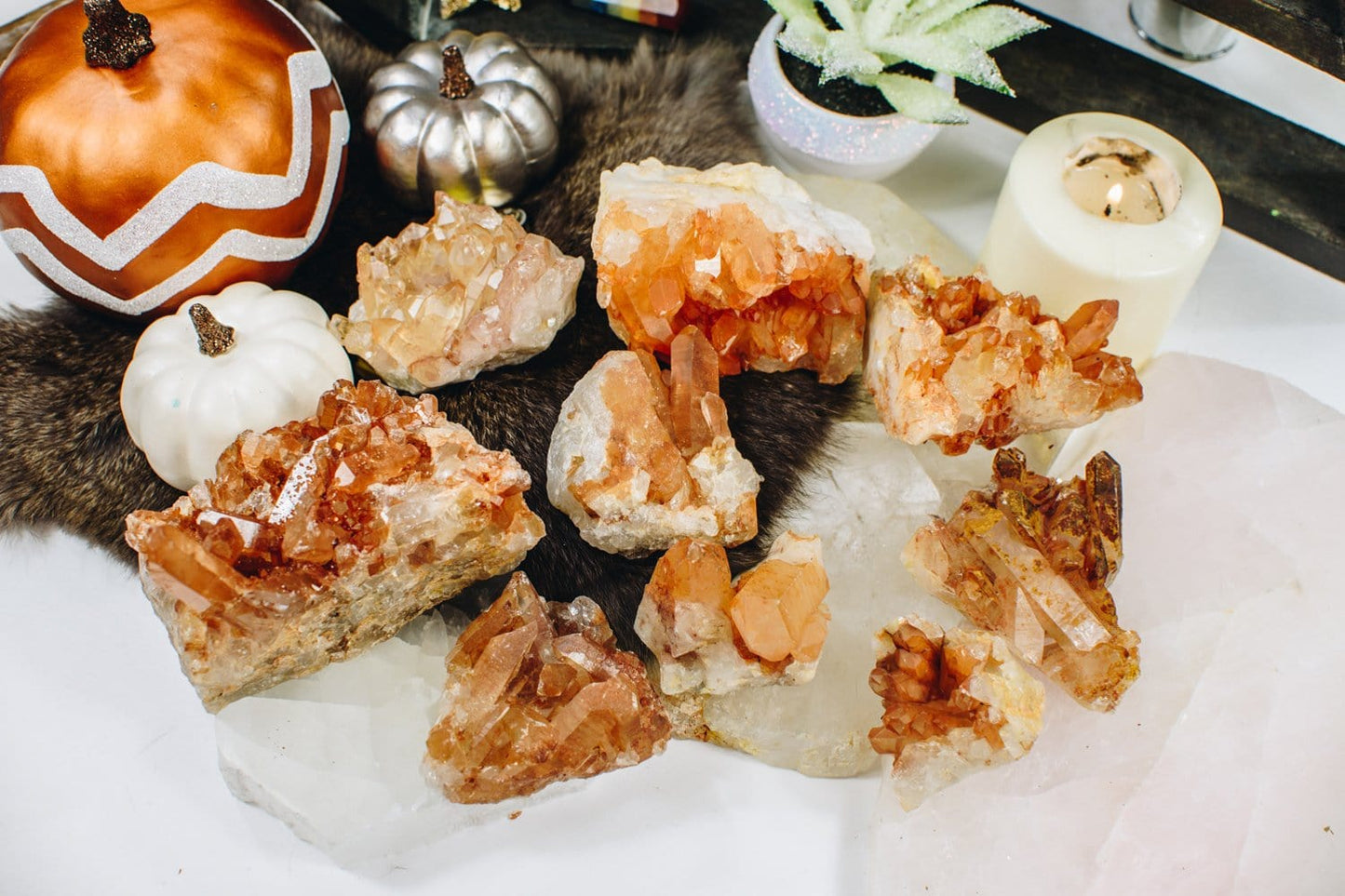 9 pieces of Tangerine Quartz Clusters surrounded by home décor