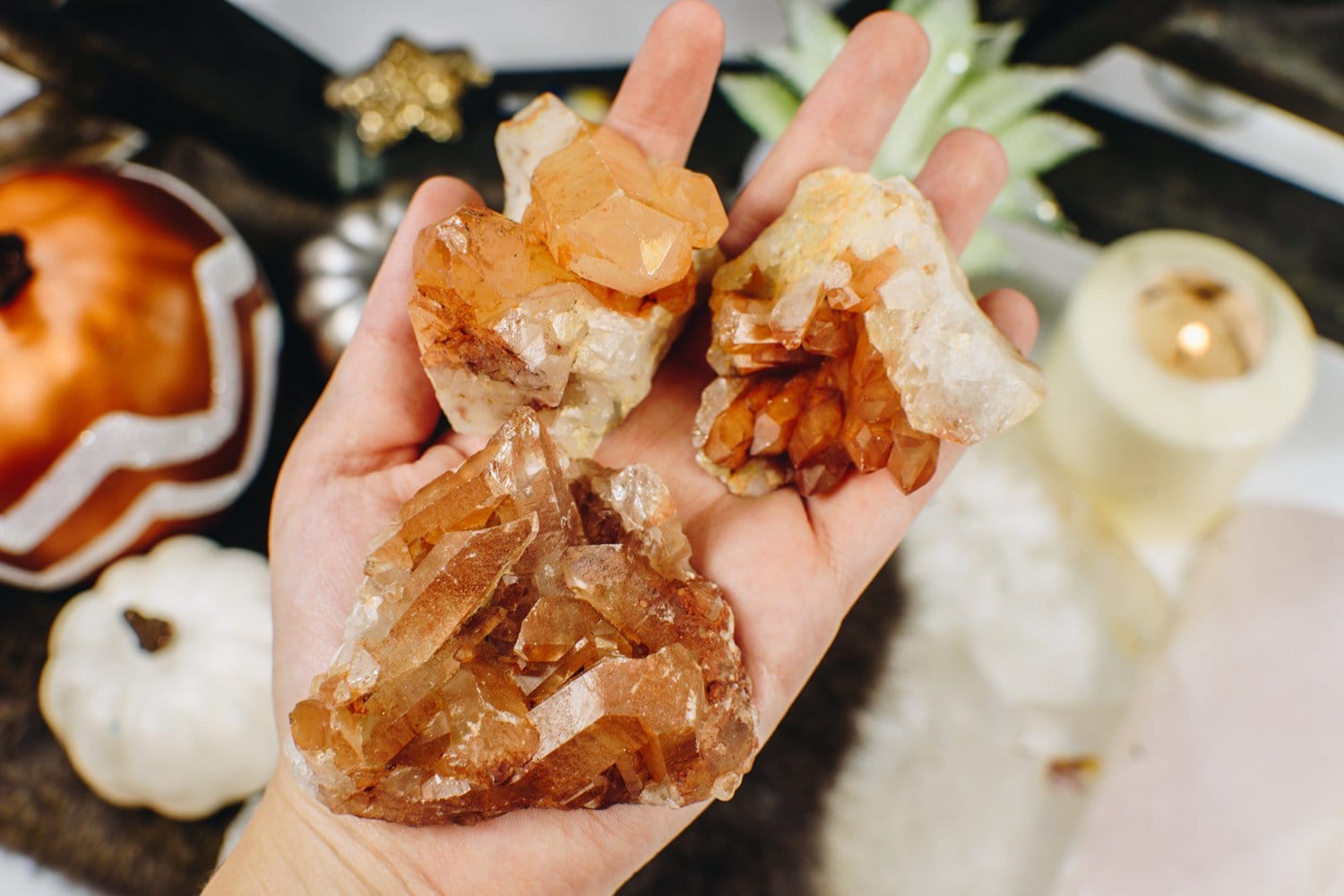 3 Tangerine Quartz Clusters held on a hand