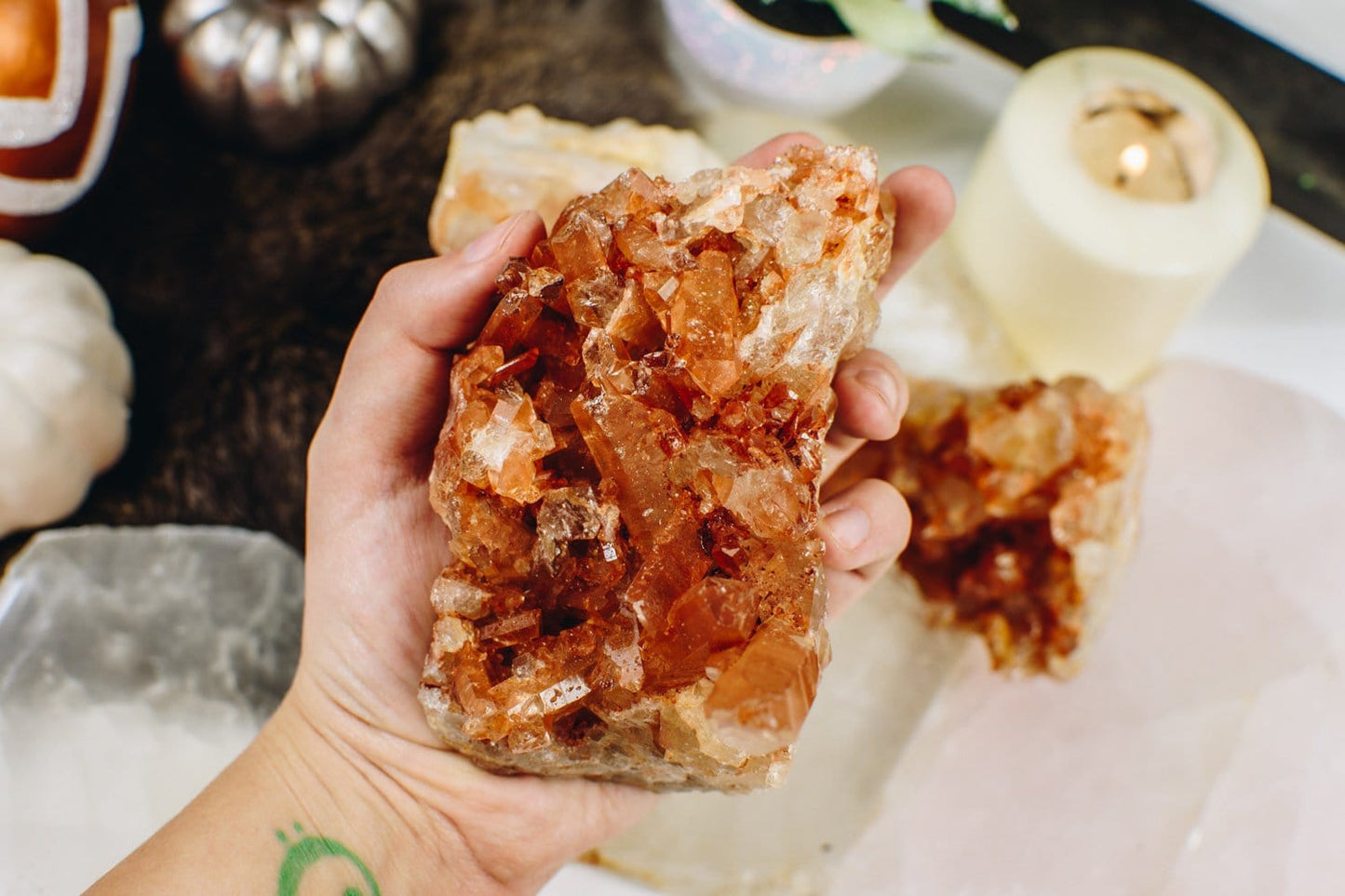 1 piece of the Tangerine Quartz Cluster held on a hand 