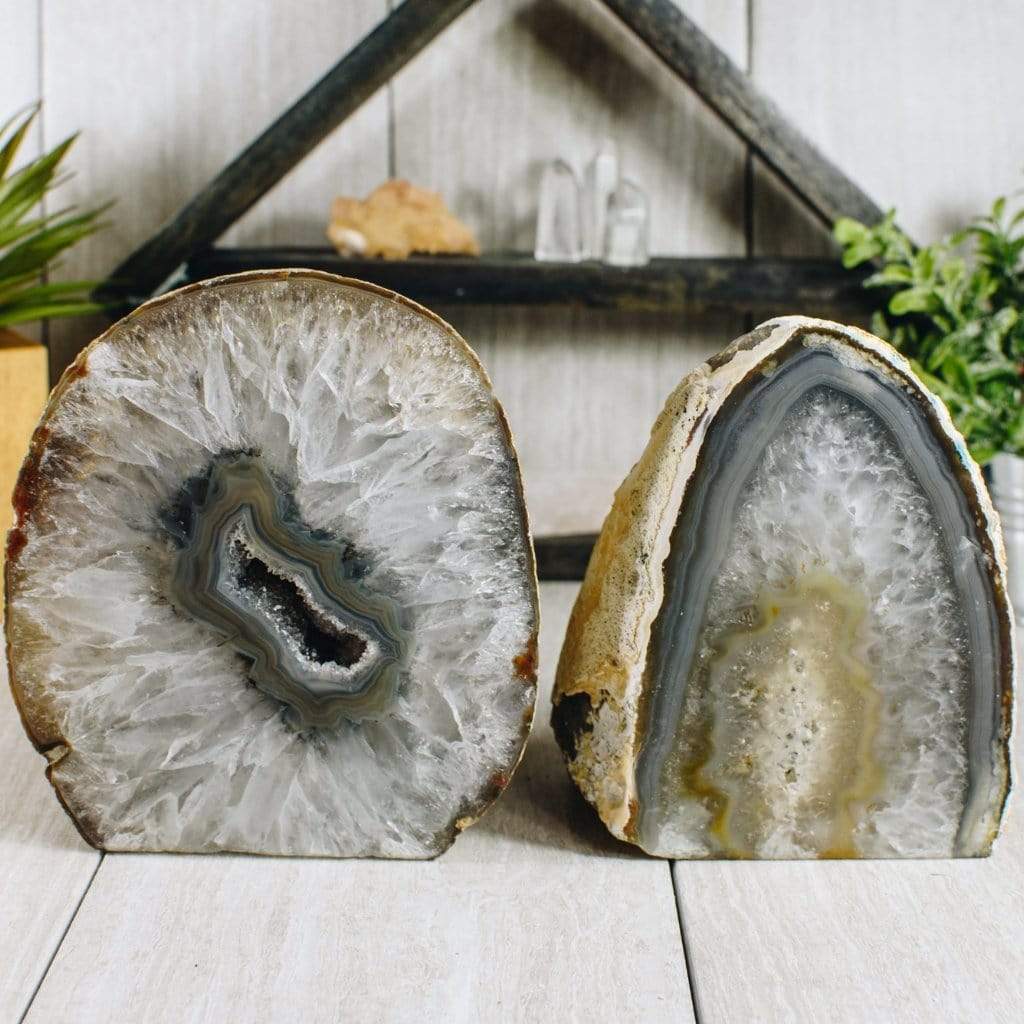 Two natural agate lamps front facing within an alter displaying pattern, shape and color variations.