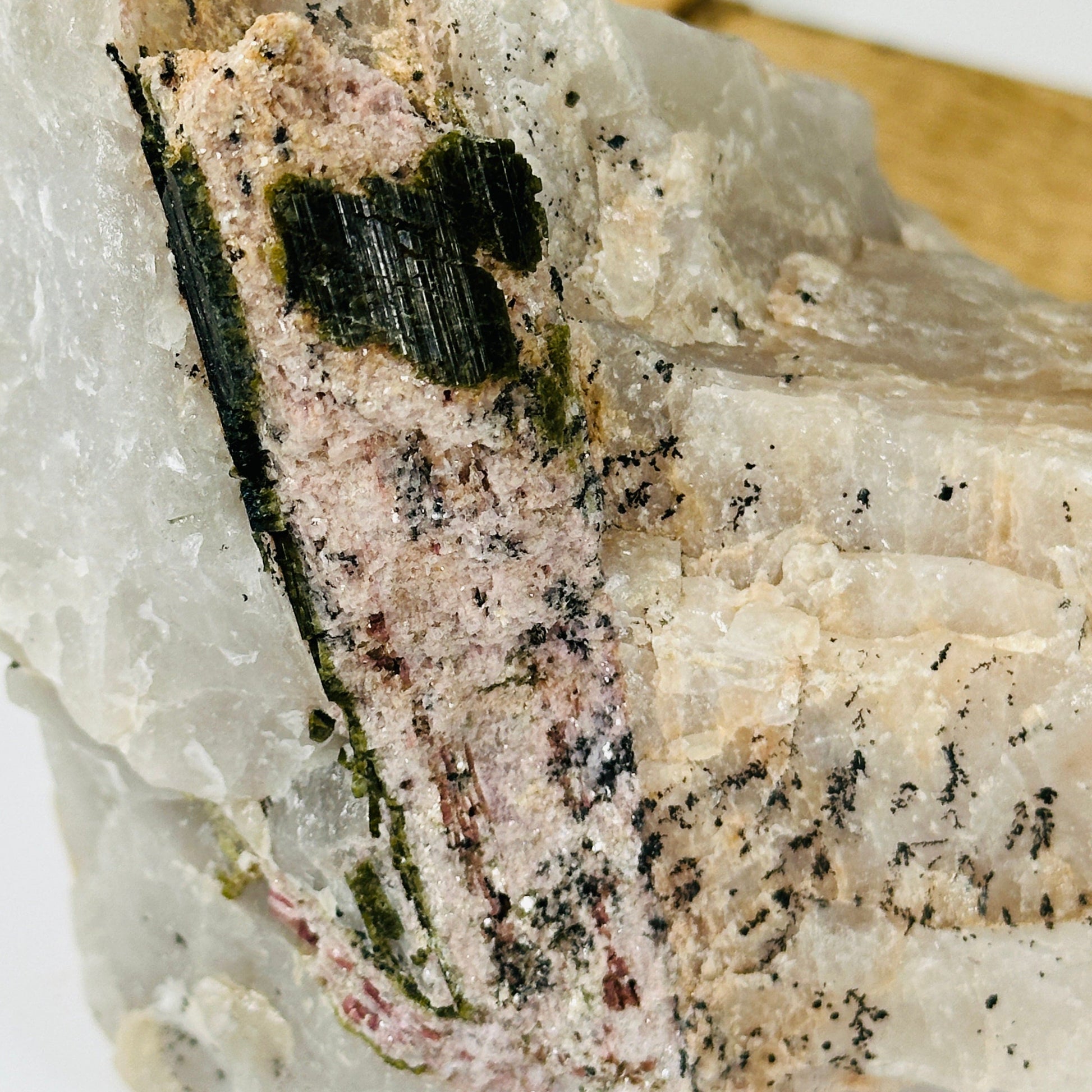 watermelon tourmaline with decorations in the background