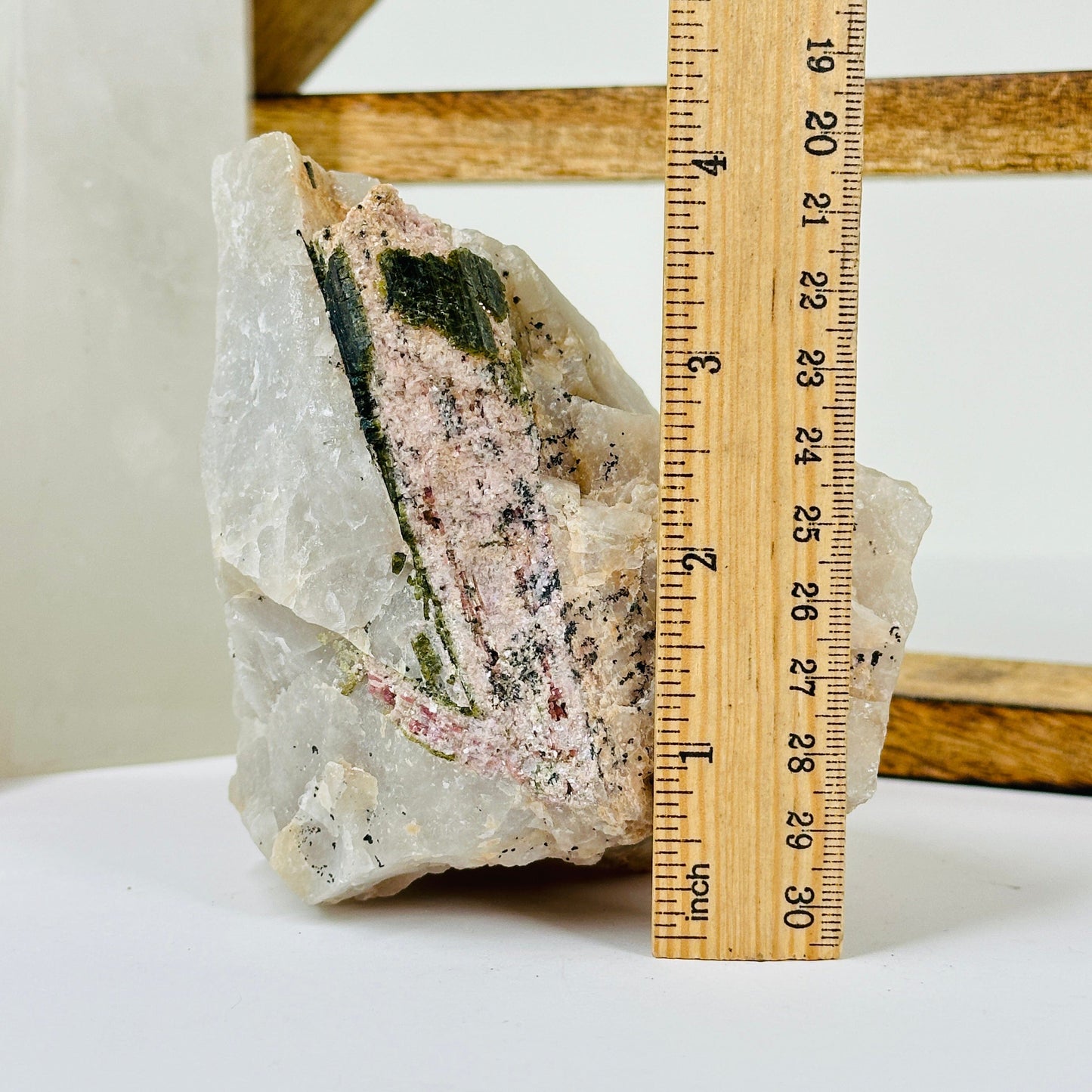 watermelon tourmaline with decorations in the background