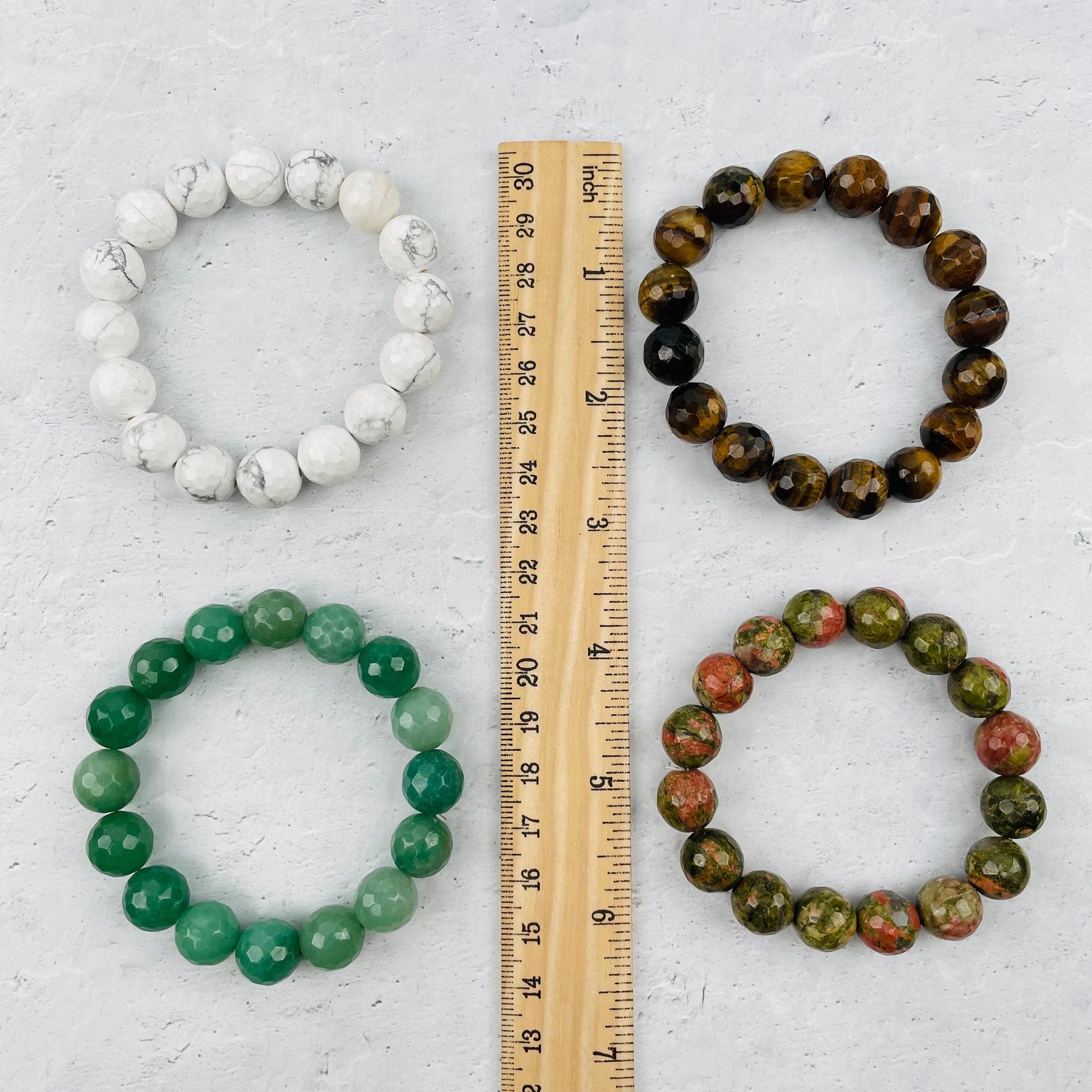 bracelets next to a ruler for size reference 