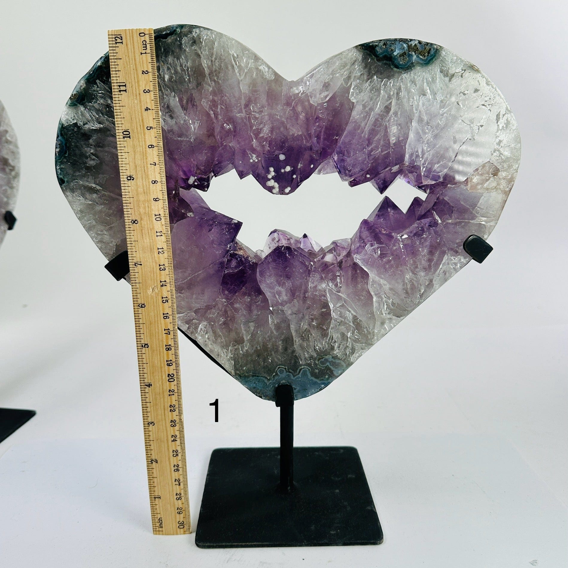 amethyst heart on stand next to a ruler for size reference