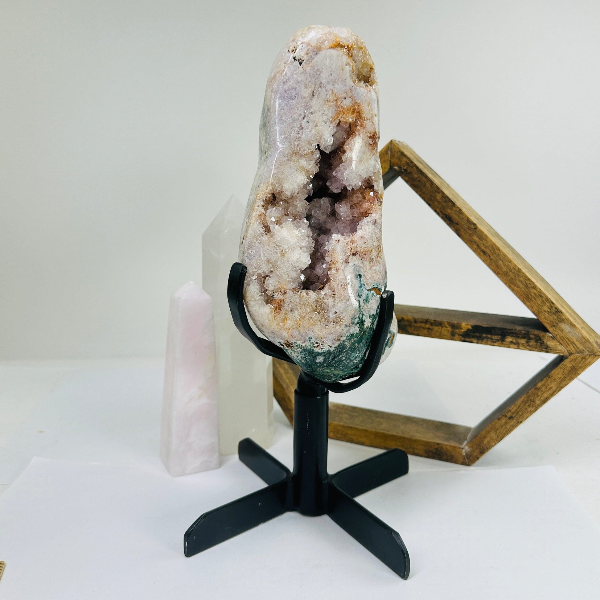 pink amethyst on stand with decorations in the background