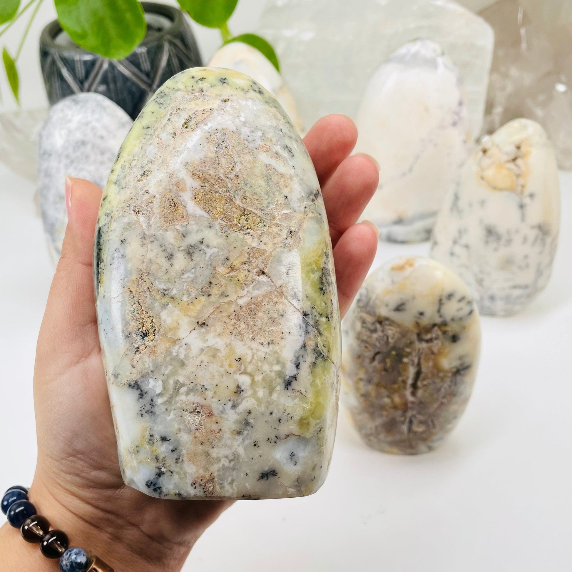 dendrite opal cut base in hand for size reference 