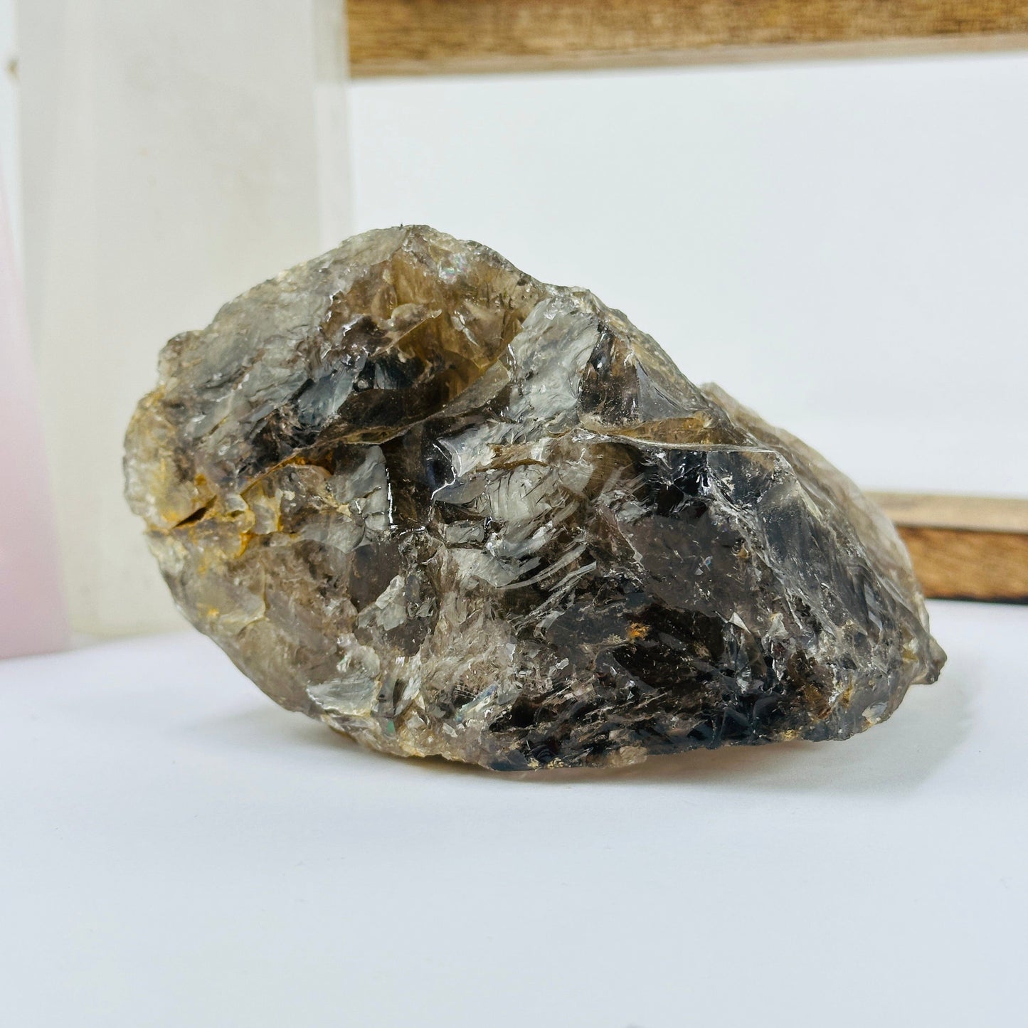 smoky quartz cluster with decorations in the background