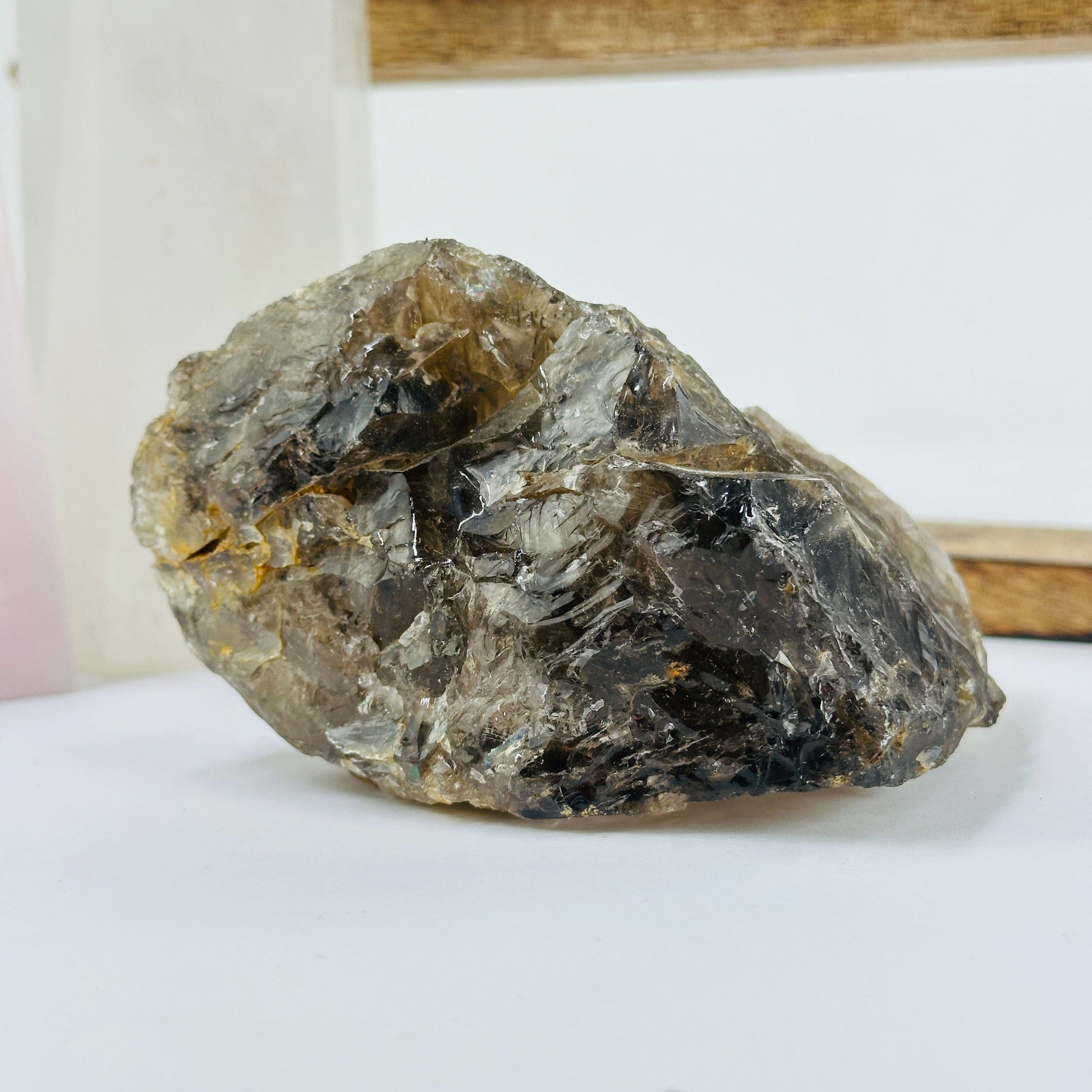 smoky quartz cluster with decorations in the background