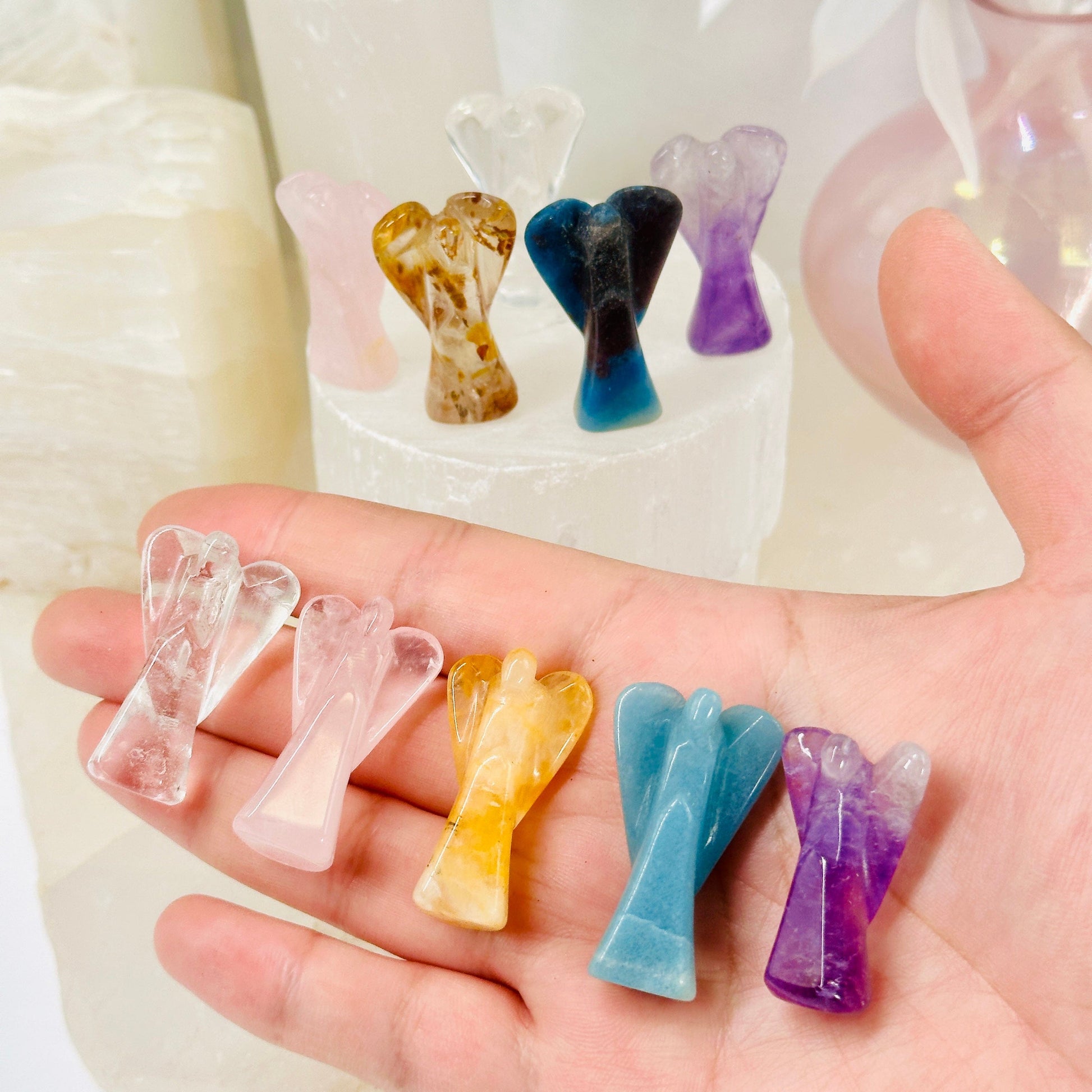 Gemstone Angels - Medium - all variants in hand with all variants in background on white pedestal