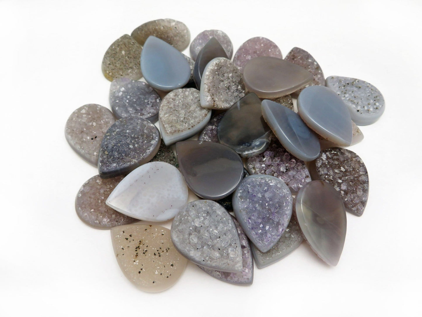 druzy teardrop cabs in a pile