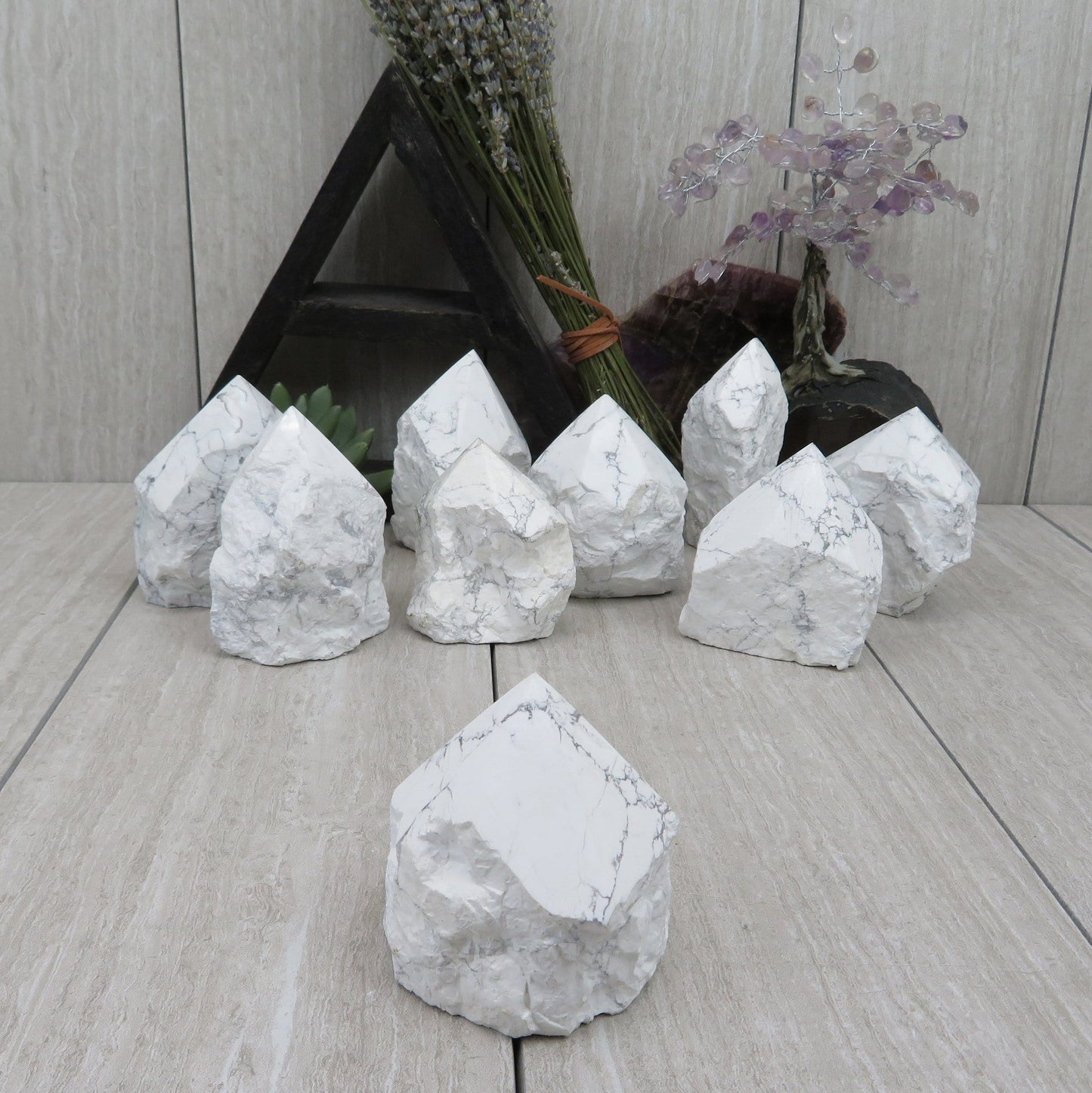 white howlite point with the top polished and the bottom left rough. Several shown to show variation