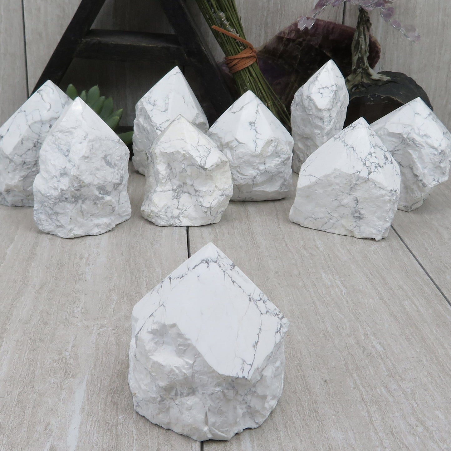 white howlite point with the top polished and the bottom left rough. Several shown to show variation.