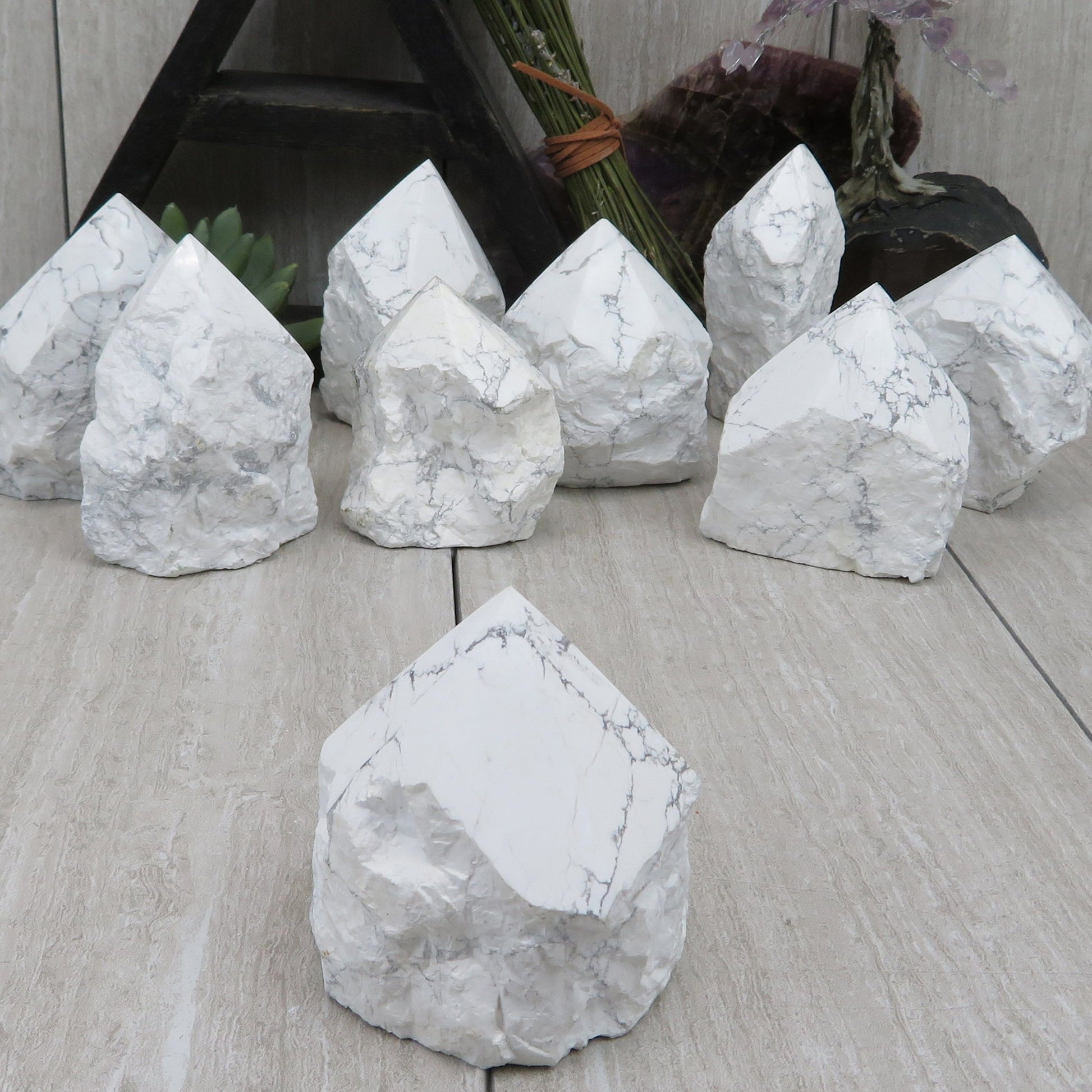 white howlite point with the top polished and the bottom left rough. Several shown to show variation.
