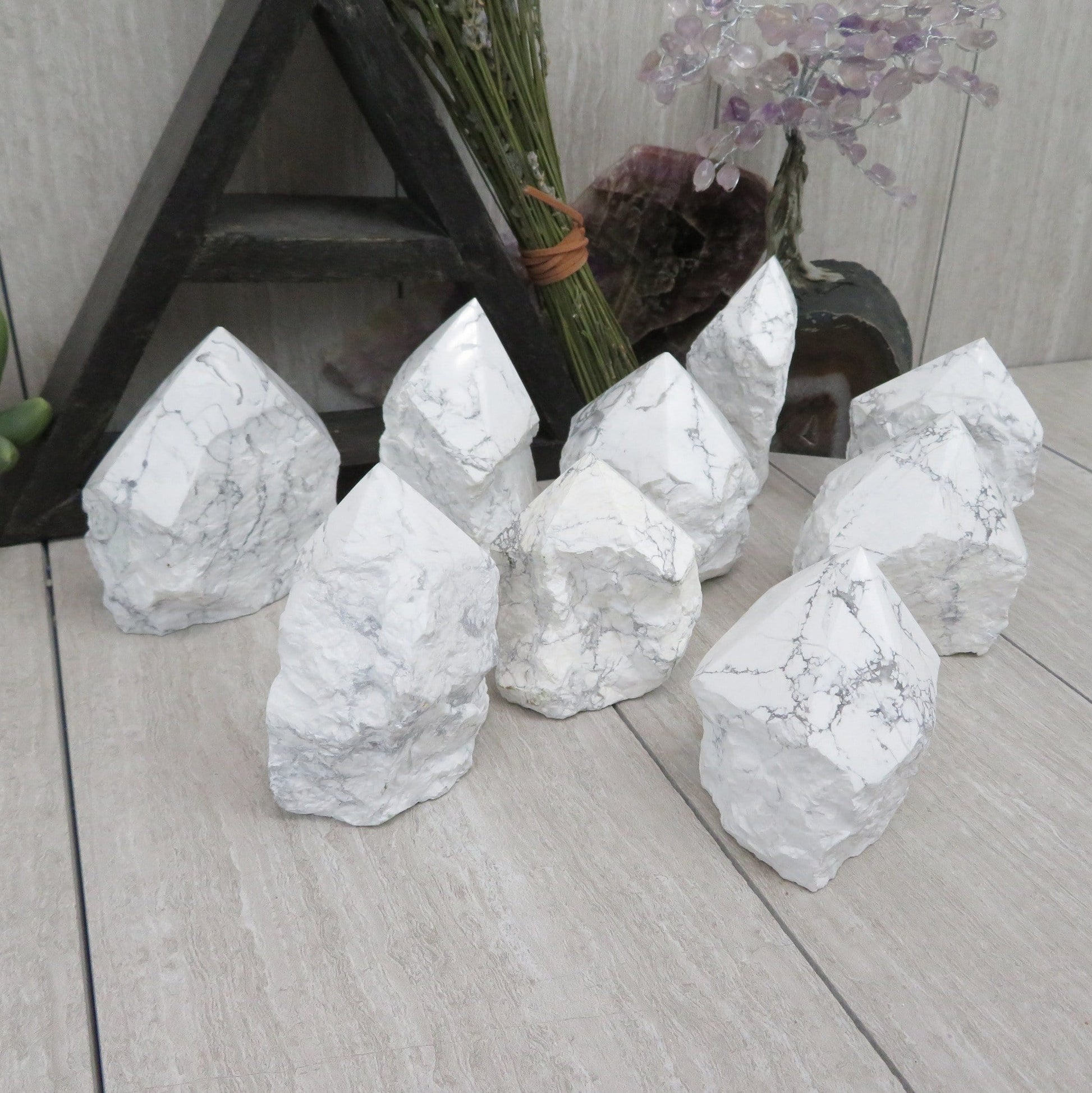 white howlite point with the top polished and the bottom left rough. Several shown to show variation.