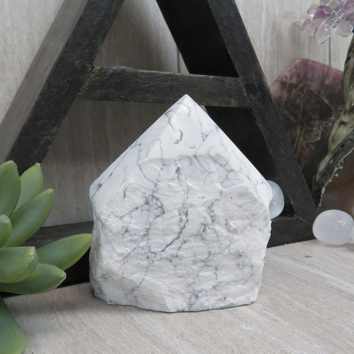 white howlite point with the top polished and the bottom left rough. 