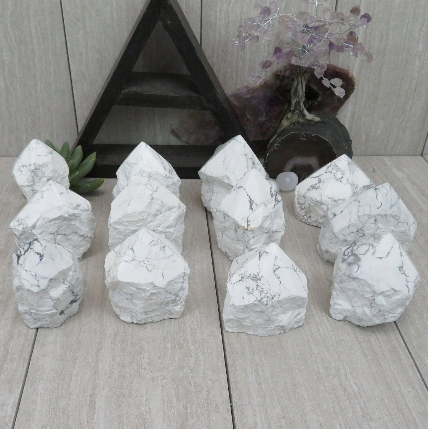 white howlite point with the top polished and the bottom left rough. Several shown to show variation.
