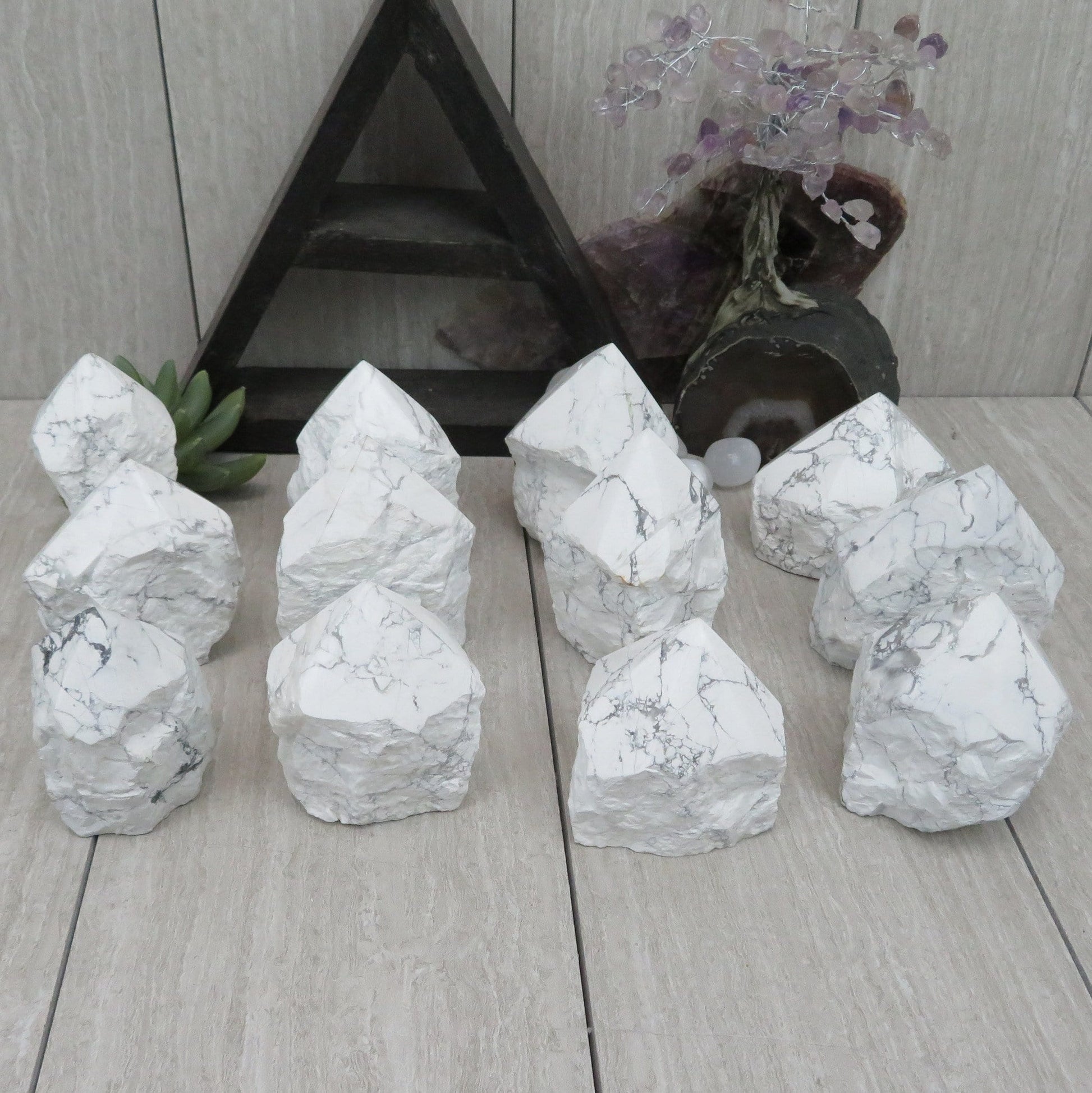 white howlite point with the top polished and the bottom left rough. Several shown to show variation.