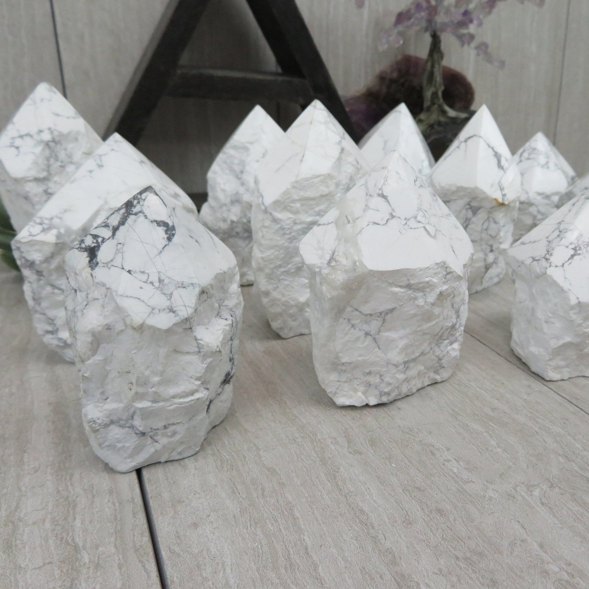 white howlite point with the top polished and the bottom left rough. Several shown to show variation.