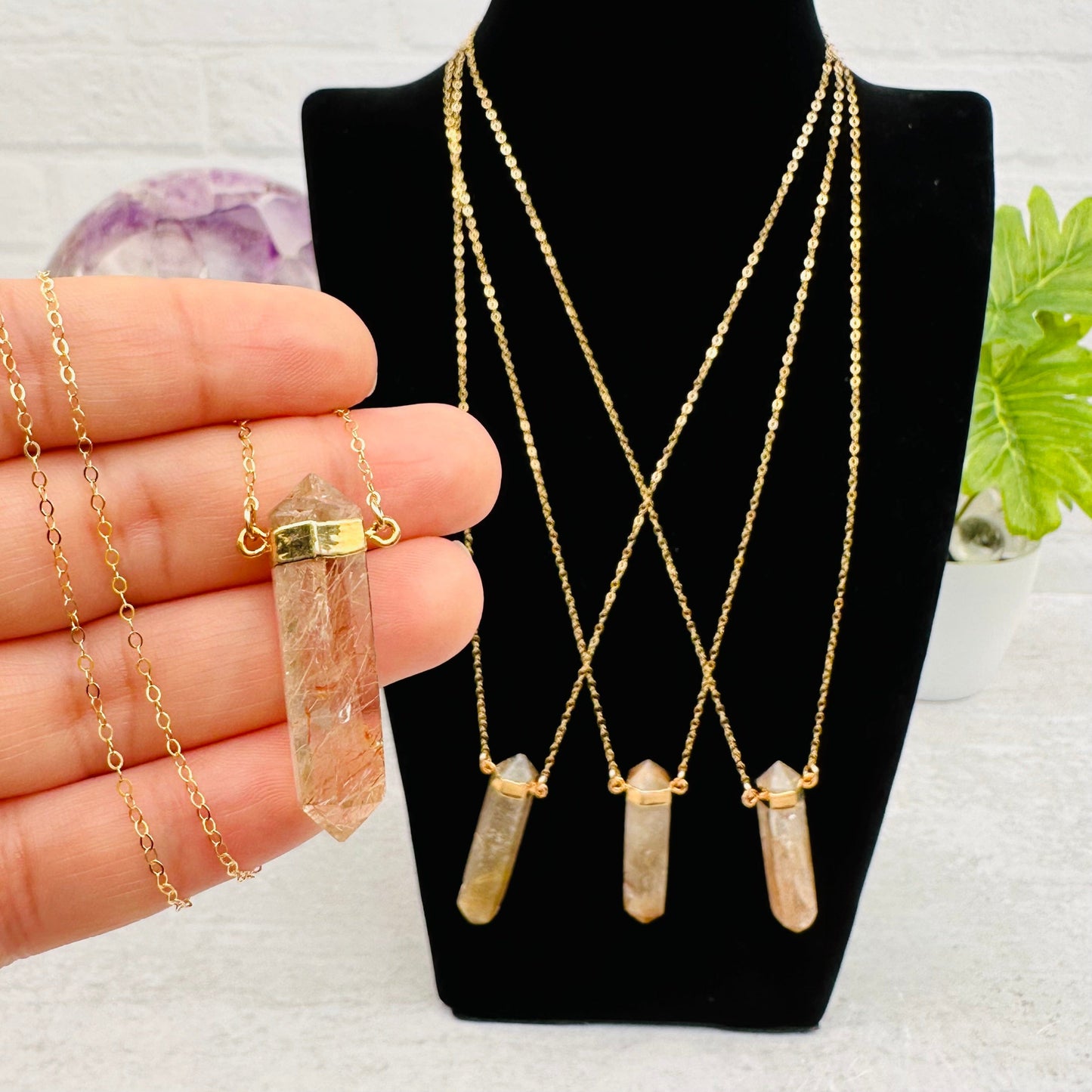 Gold Rutilated Double Terminated Point Necklace with 14k Gold in hand for size reference 