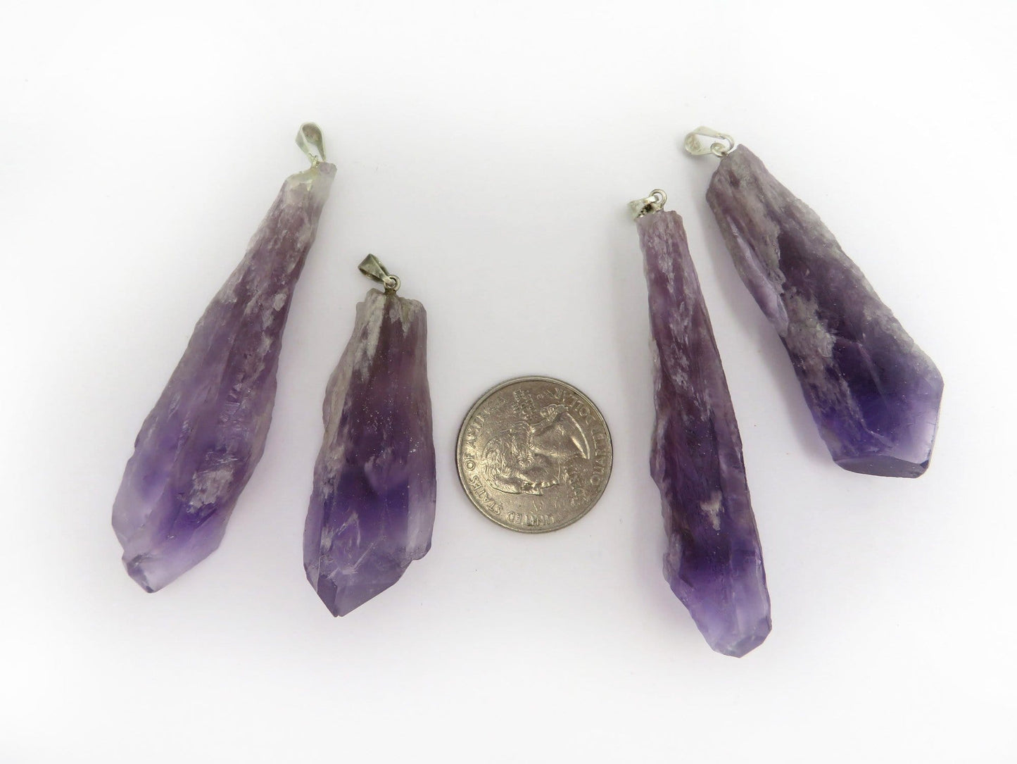 pendants next to a quarter for size reference 