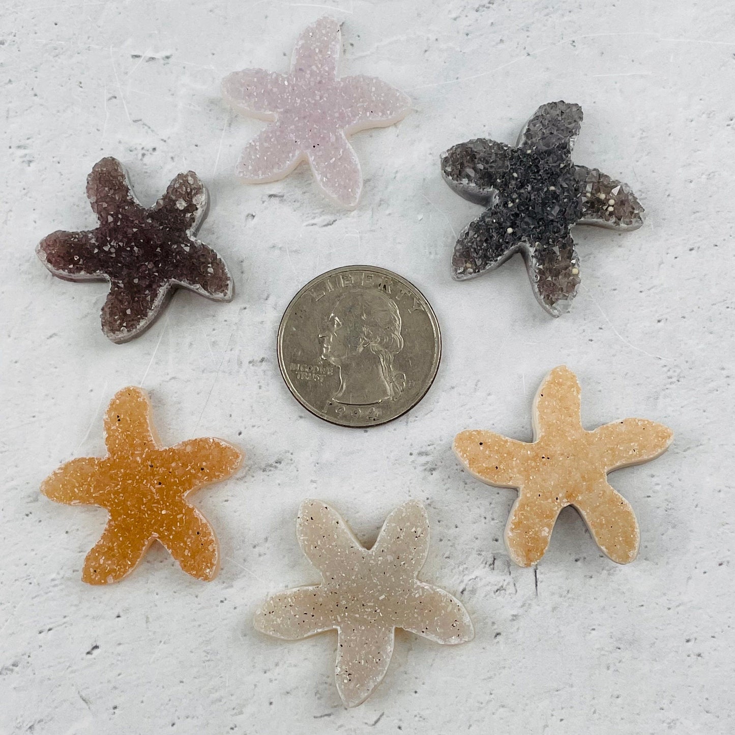 cabochons next to a quarter for size reference 