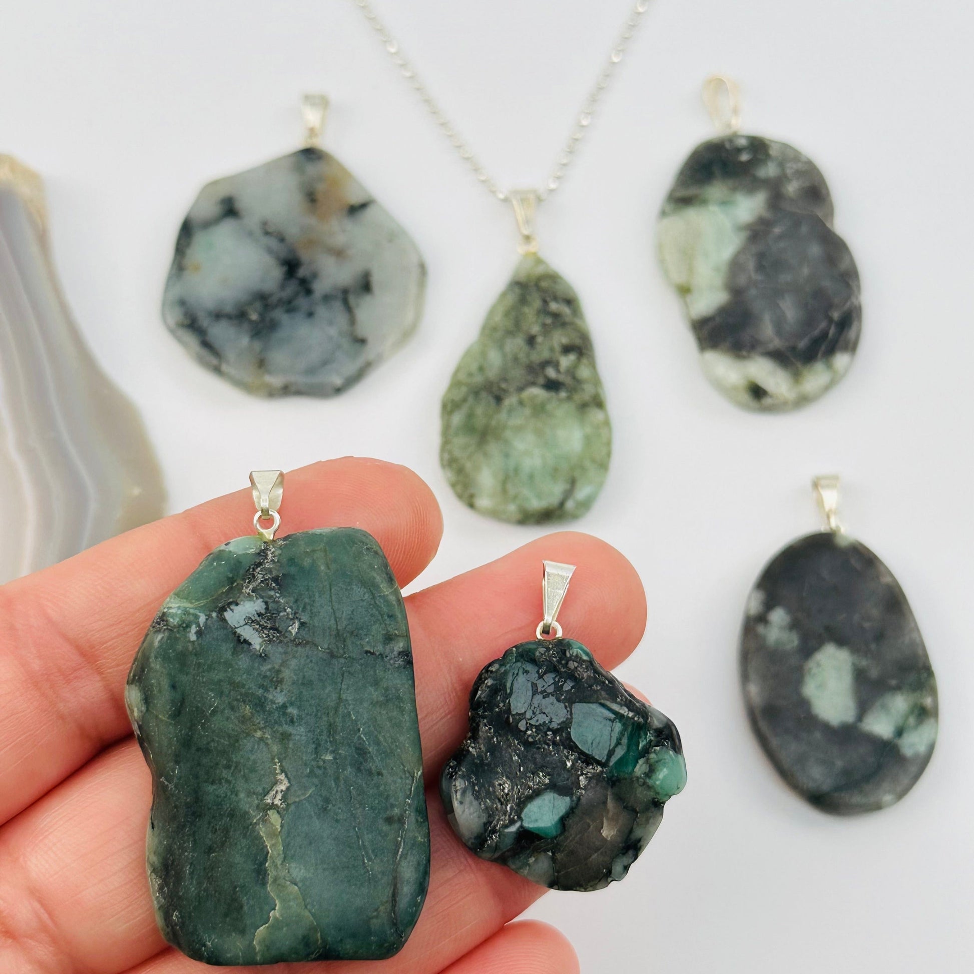 Emerald Slab Slice Pendant with Silver tone Bail in hand for size reference 
