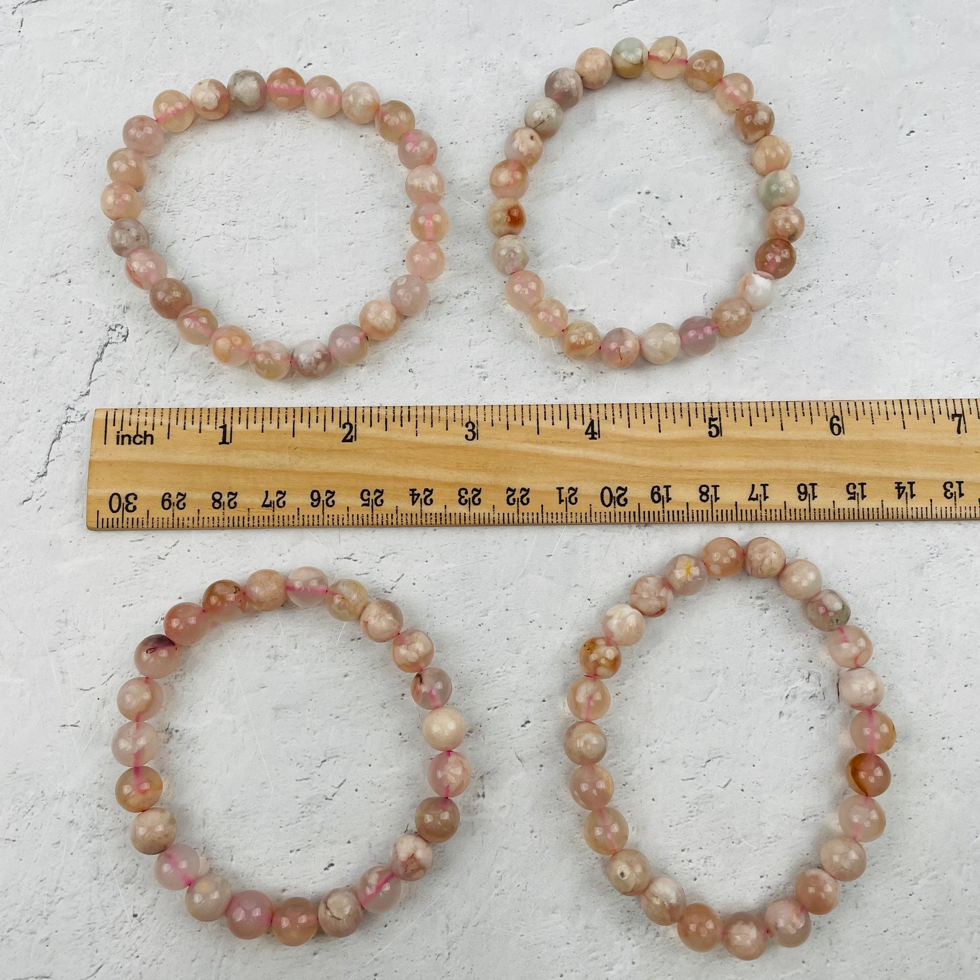 bracelets next to a ruler for size reference 