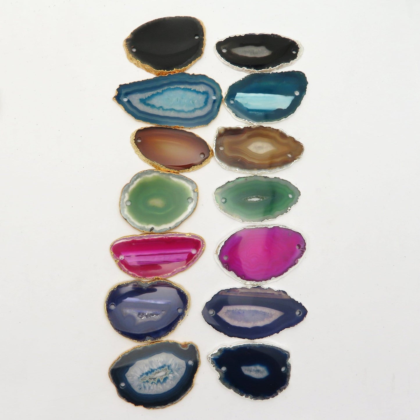 Picture of all the variety of colors we have available for our agate slice plated edge double drilled pendants, displayed on a white background.