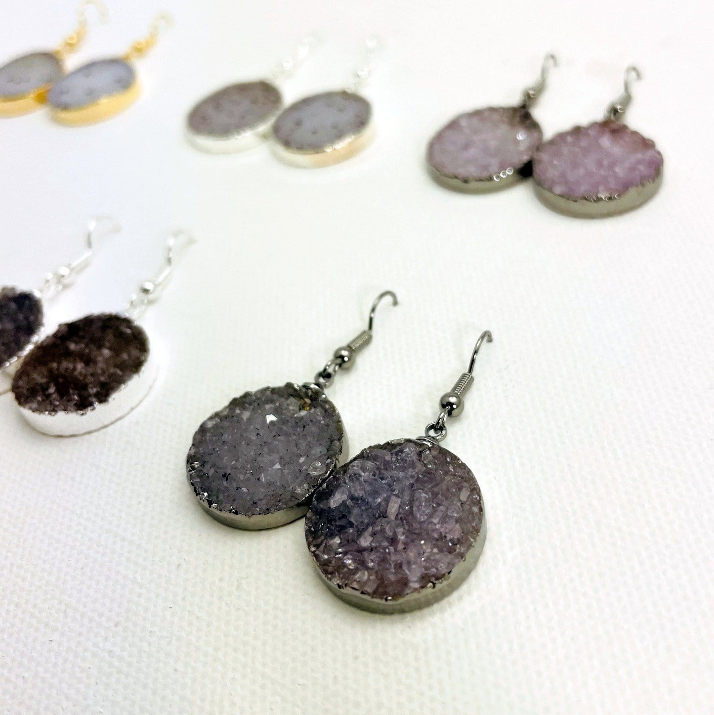 Close up of assorted druzy earrings.