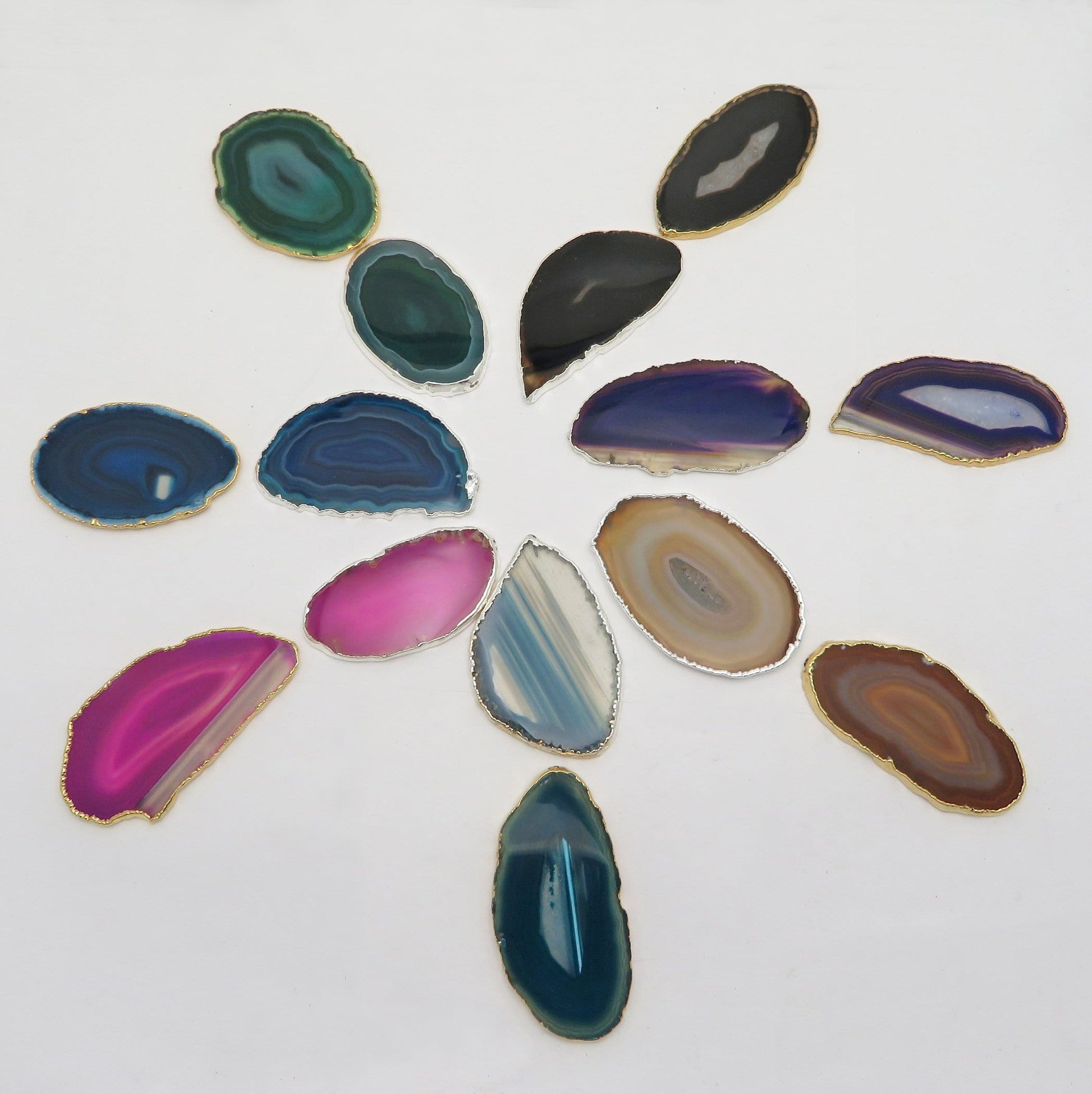 This picture is showing all the variety of colors we have available for our agate slices plated edge, on a white background.