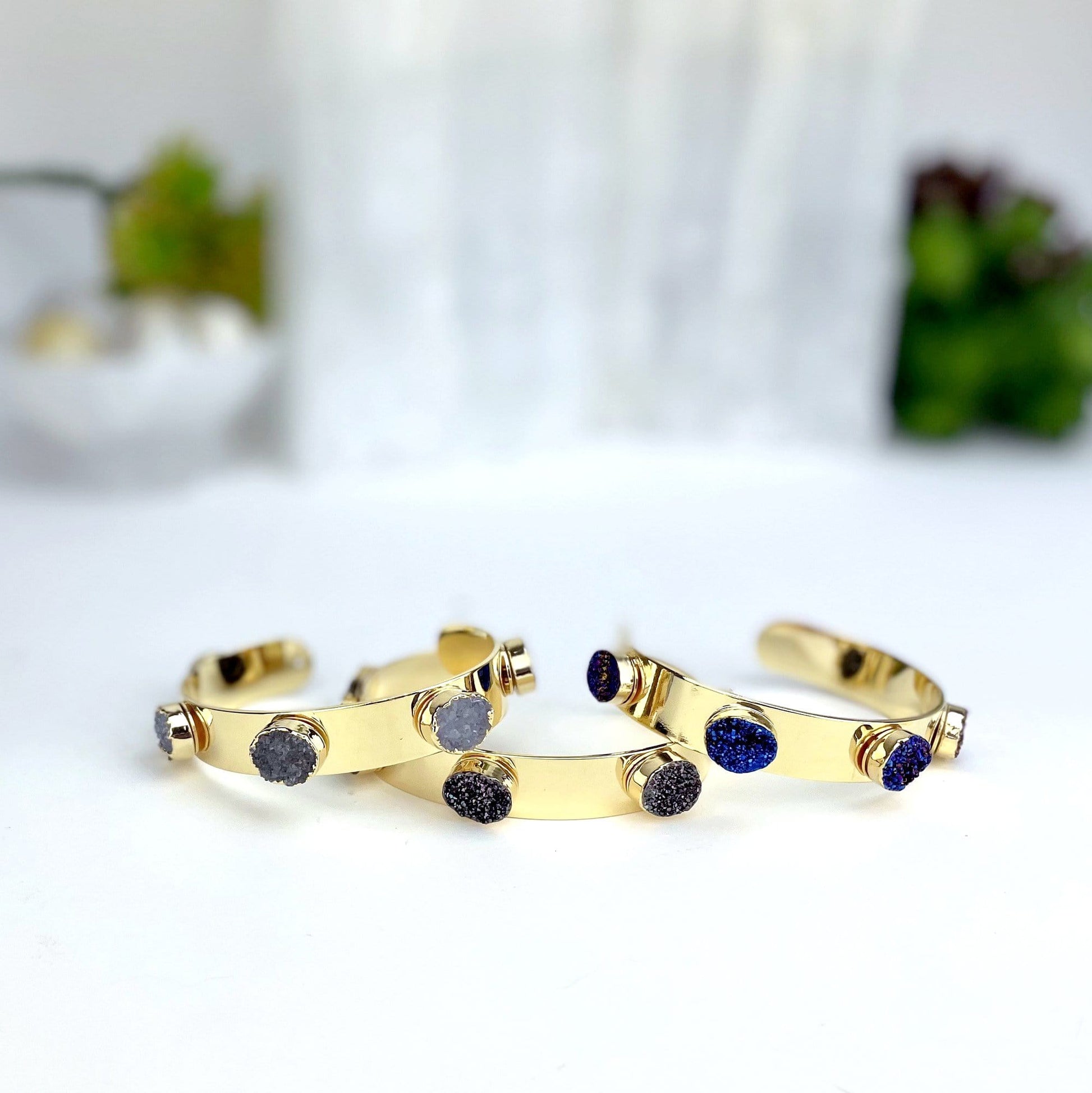 multiple druzy adjustable bracelets displayed to show the differences in the druzy colors 