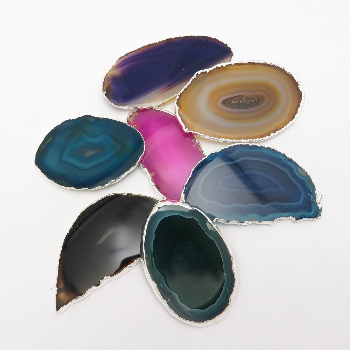 This picture is showing all the variety of colors we have available for our agate slices plated edge, on a white background.
