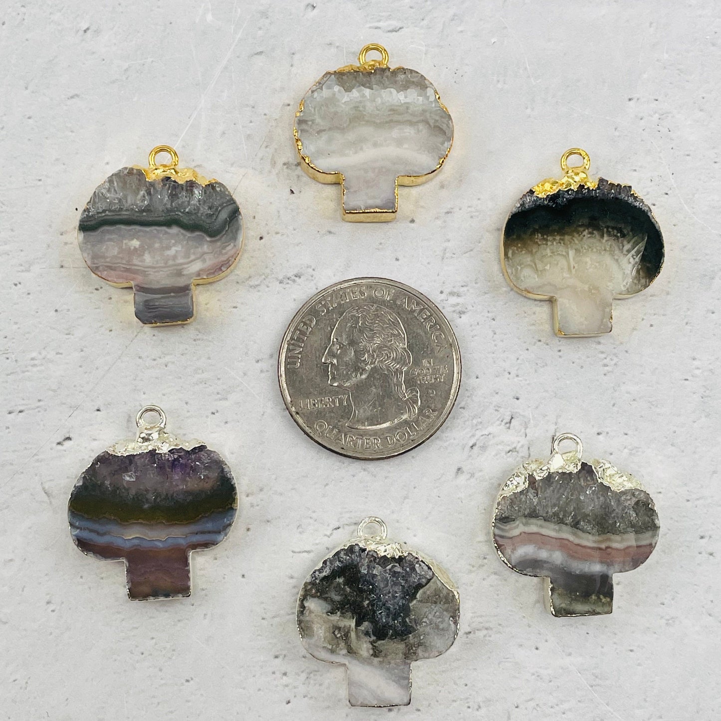pendants next to a quarter for size reference 